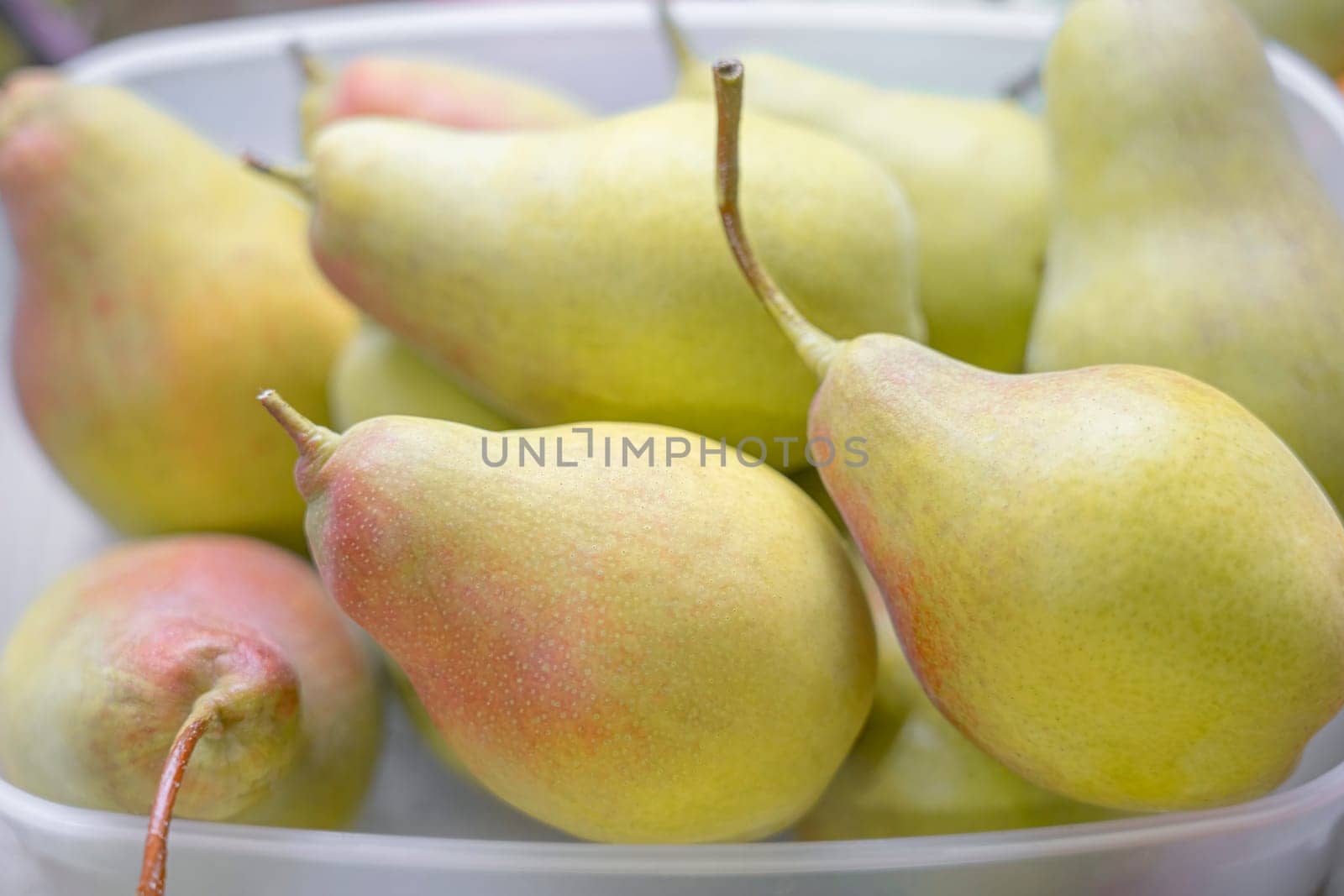 ripe yellow pear fruits on a plate close-up macro by roman112007