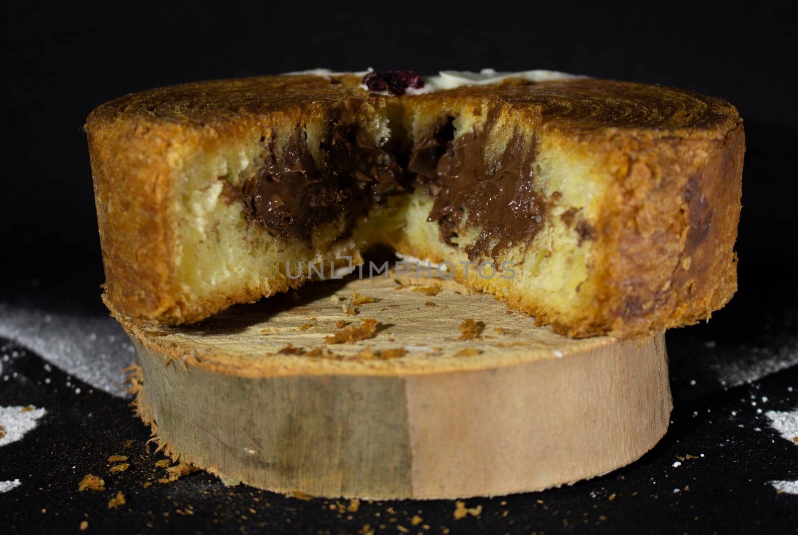 Chocolate filled cake open in two parts with chocolate inside. High quality photo