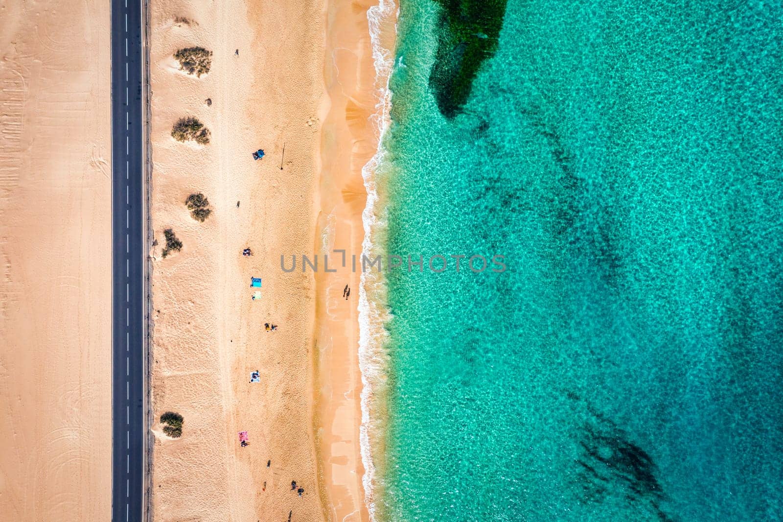 Aerial view of beach in Corralejo Park, Fuerteventura, Canary Islands. Corralejo Beach (Grandes Playas de Corralejo) on Fuerteventura, Canary Islands, Spain. Beautiful turquoise water and white sand.