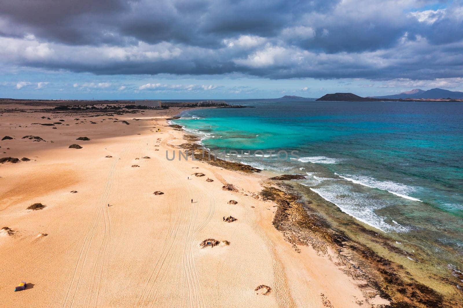 Aerial view of beach in Corralejo Park, Fuerteventura, Canary Islands. Corralejo Beach (Grandes Playas de Corralejo) on Fuerteventura, Canary Islands, Spain. Beautiful turquoise water and white sand.