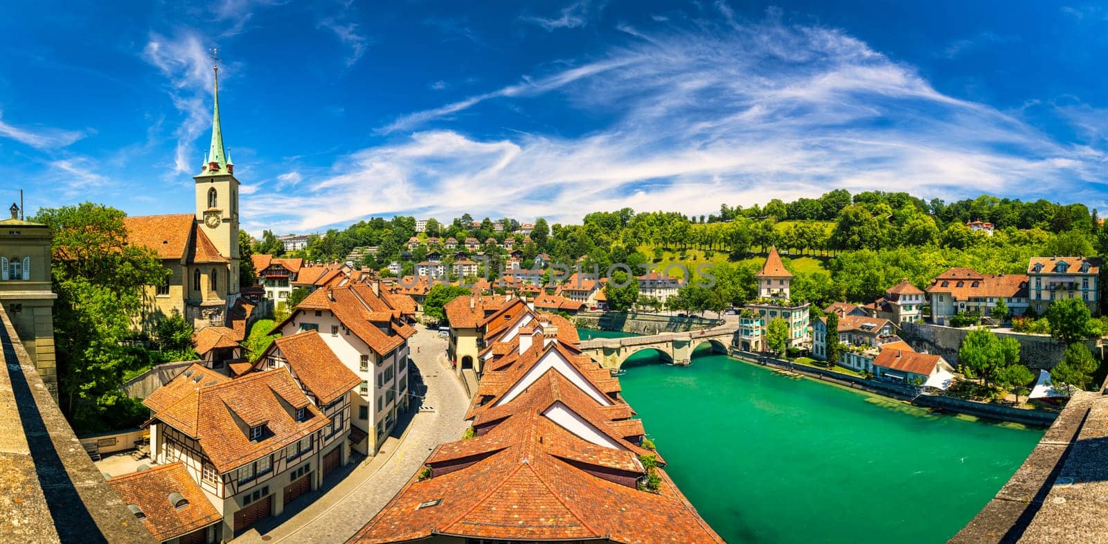 View of the Bern old city center and Nydeggbrucke bridge over river Aare, Bern, Switzerland. Bern old town with the Aare river flowing around the town on a sunny day, Bern, Switzerland.