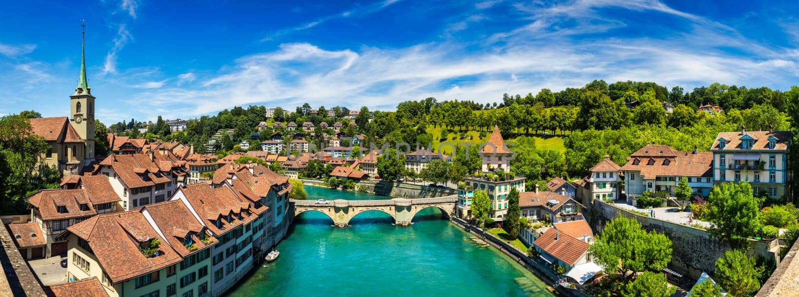 View of the Bern old city center and Nydeggbrucke bridge over river Aare, Bern, Switzerland. Bern old town with the Aare river flowing around the town on a sunny day, Bern, Switzerland.