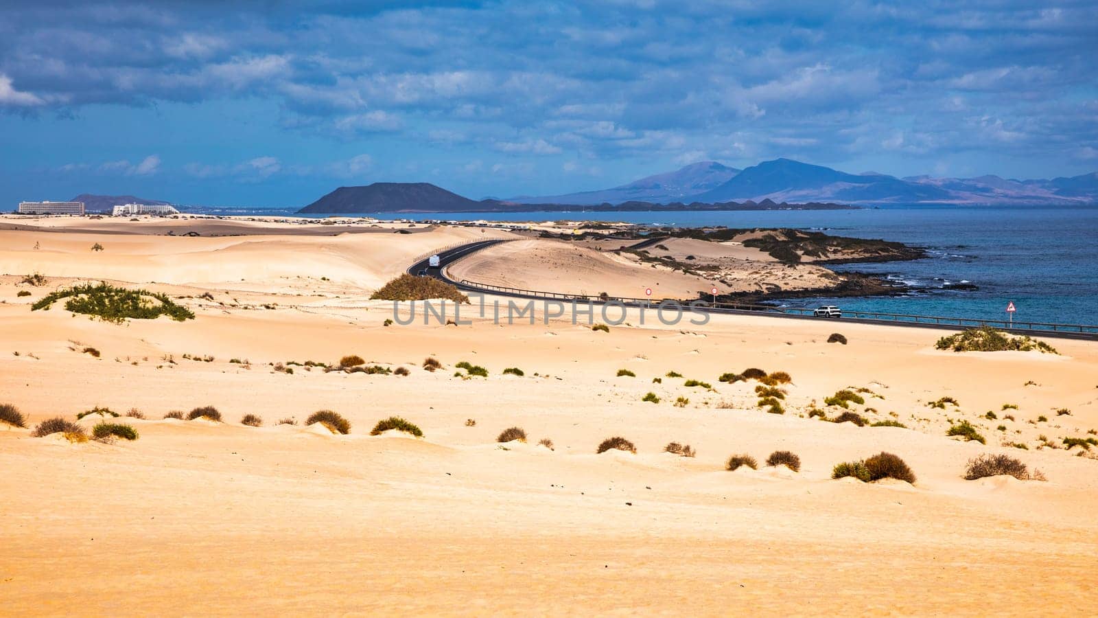 Sand dunes, Las Dunas de Corralejo, Corralejo Natural Park, dramatic cloud formation, Fuerteventura, Canary Islands, Spain. Sand dunes landscape, Corralejo, Fuerteventura, Canary Islands, Spain.