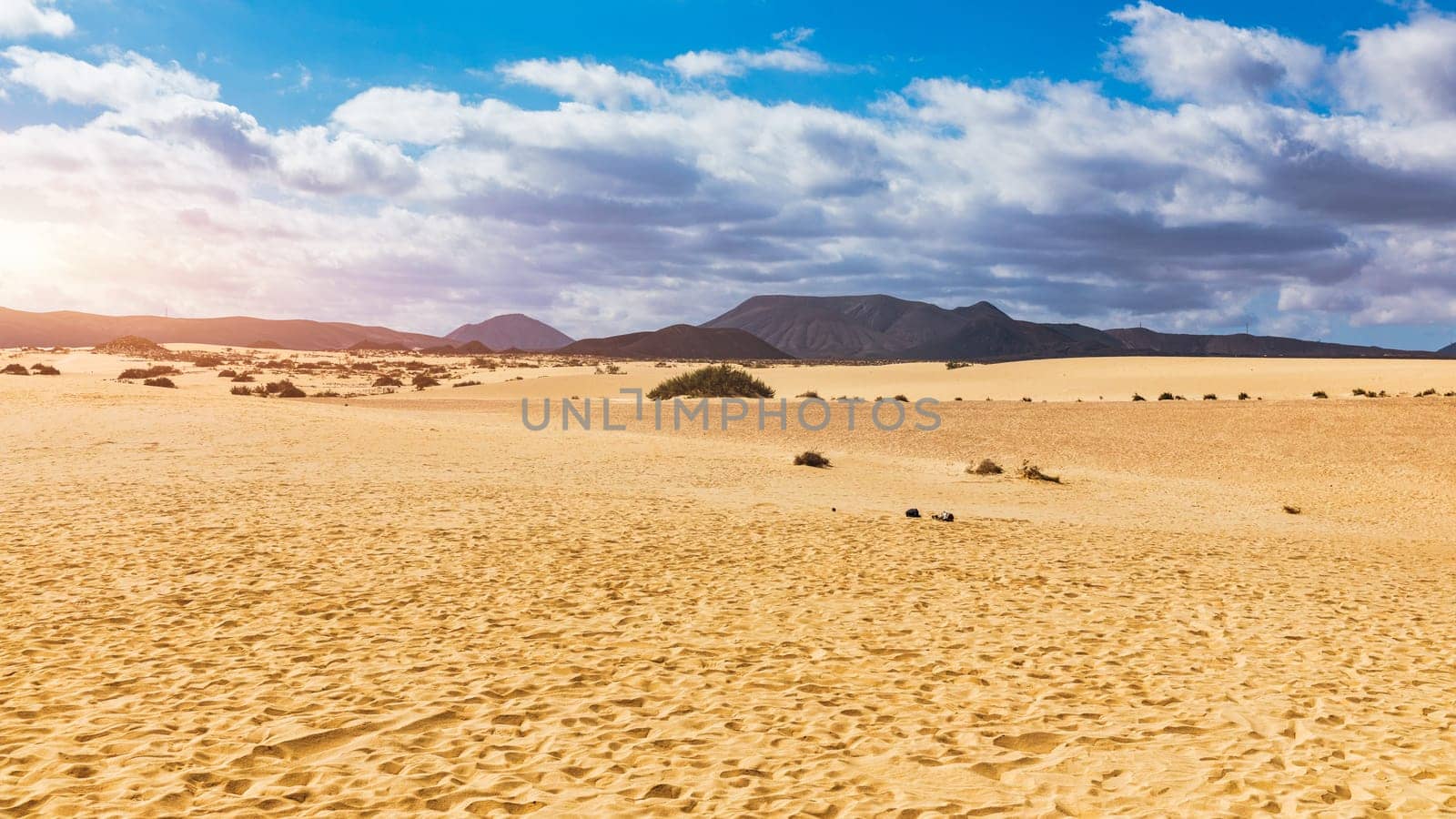 Sand dunes, Las Dunas de Corralejo, Corralejo Natural Park, dramatic cloud formation, Fuerteventura, Canary Islands, Spain. Sand dunes landscape, Corralejo, Fuerteventura, Canary Islands, Spain.