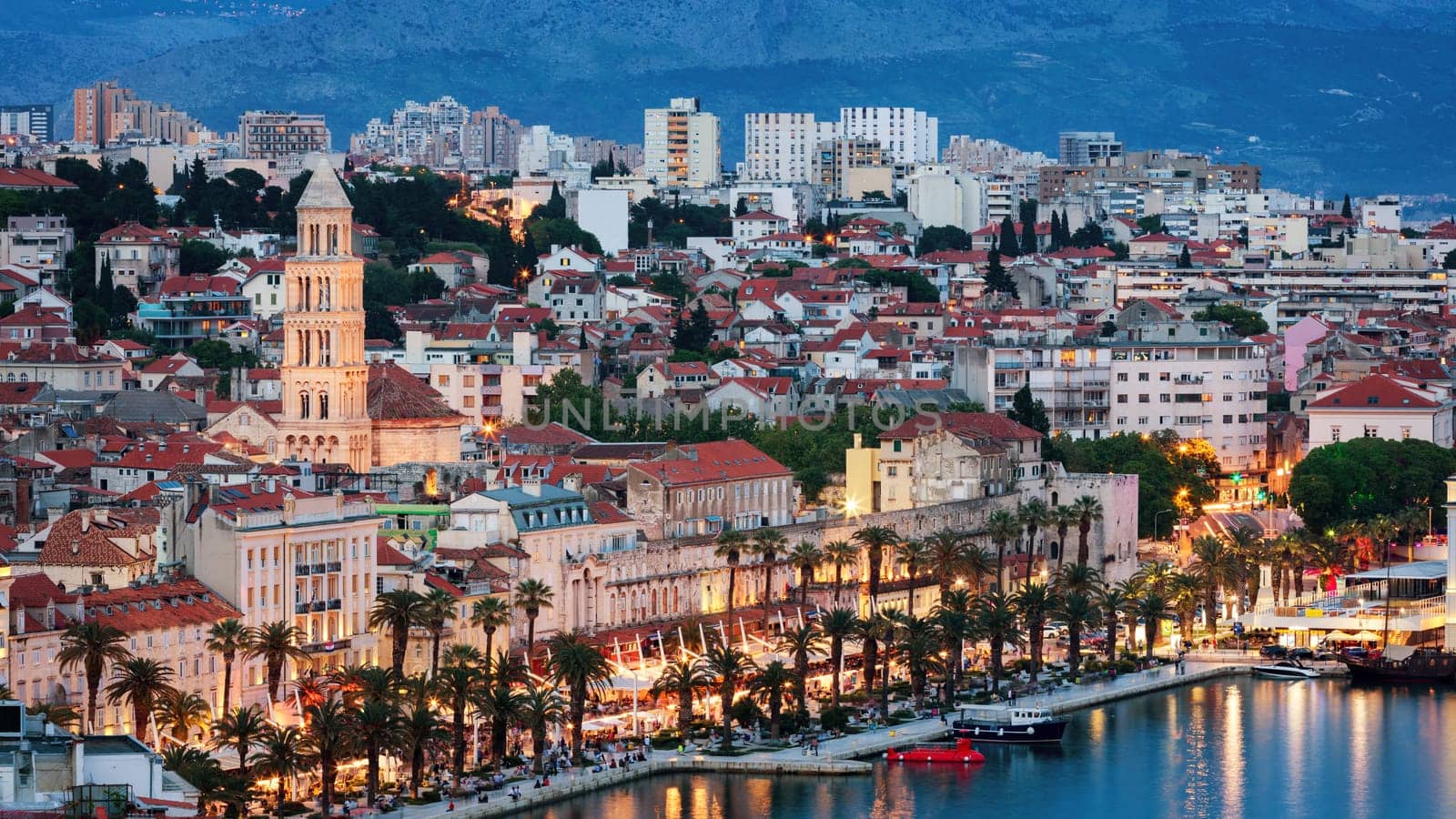 Amazing Split city waterfront panorama at blue hour, Dalmatia, Europe. Roman Palace of the Emperor Diocletian and tower of Saint Domnius cathedral. Split, Croatia. 