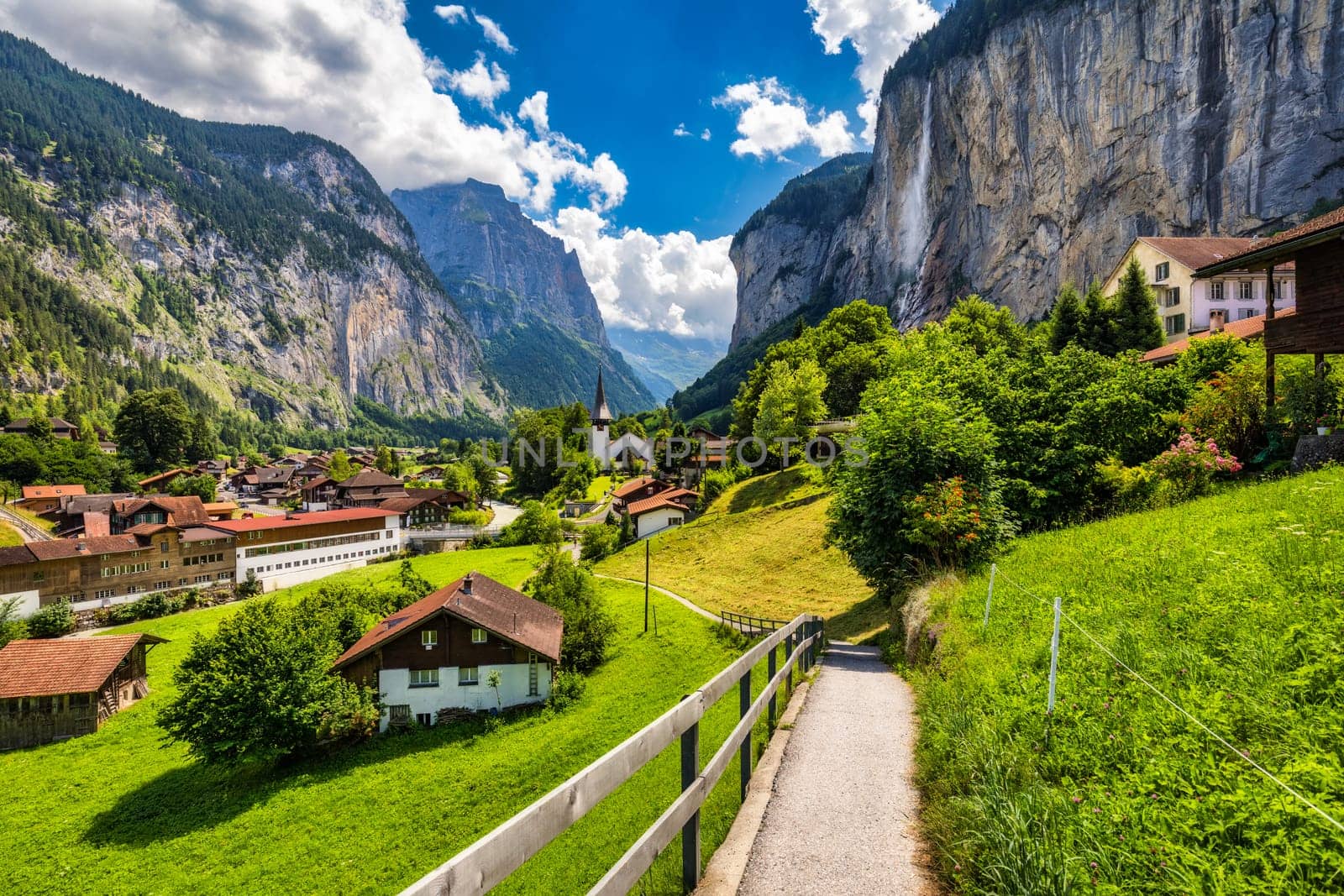 Famous Lauterbrunnen town and Staubbach waterfall, Bernese Oberland, Switzerland, Europe. Lauterbrunnen valley, Village of Lauterbrunnen, the Staubbach Fall, and the Lauterbrunnen Wall in Swiss Alps.