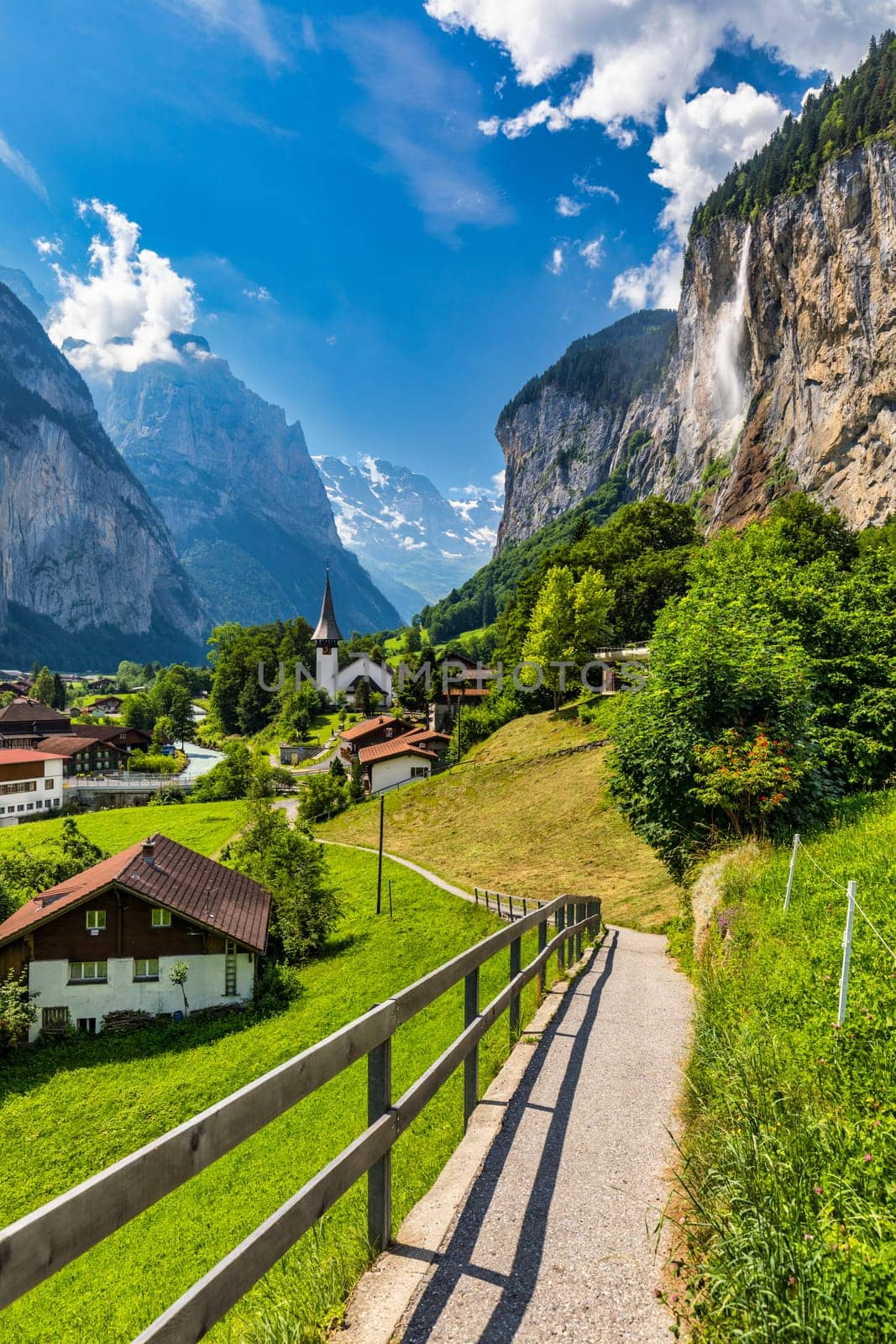 Famous Lauterbrunnen town and Staubbach waterfall, Bernese Oberland, Switzerland, Europe. Lauterbrunnen valley, Village of Lauterbrunnen, the Staubbach Fall, and the Lauterbrunnen Wall in Swiss Alps.