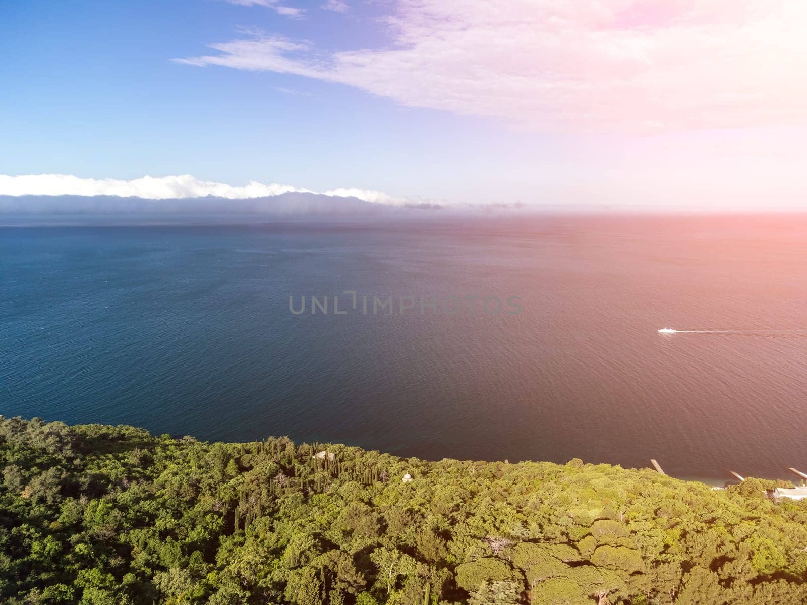 Aerial sea clouds. Panoramic view of seascape with crystal clear azure sea. Yachts in a beautiful lagoon on backdrop of rocks. The concept of an ideal destination for summer travel and vacation. by panophotograph