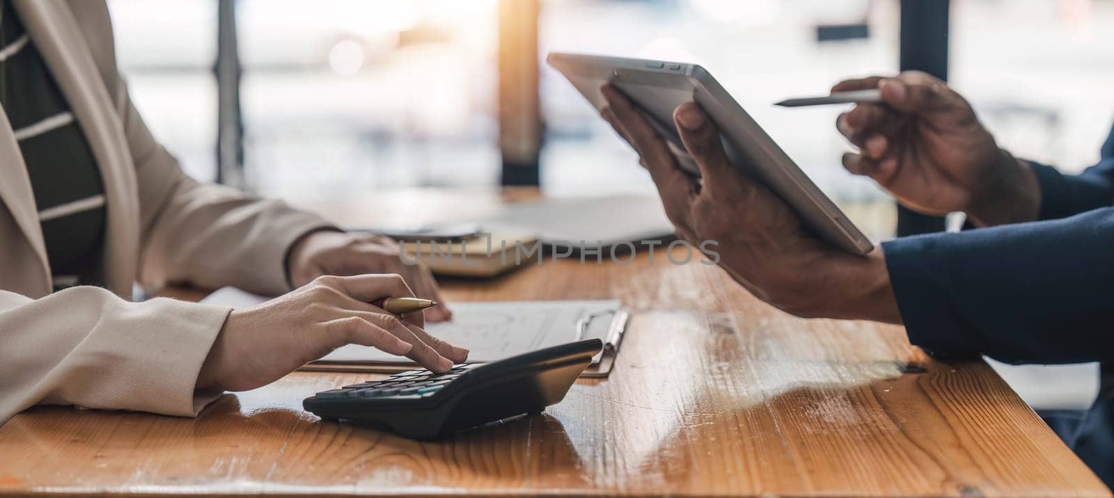 Business People Meeting using laptop computer,calculator,notebook,stock market chart paper for analysis Plans to improve quality next month. Conference Discussion Corporate Concept....