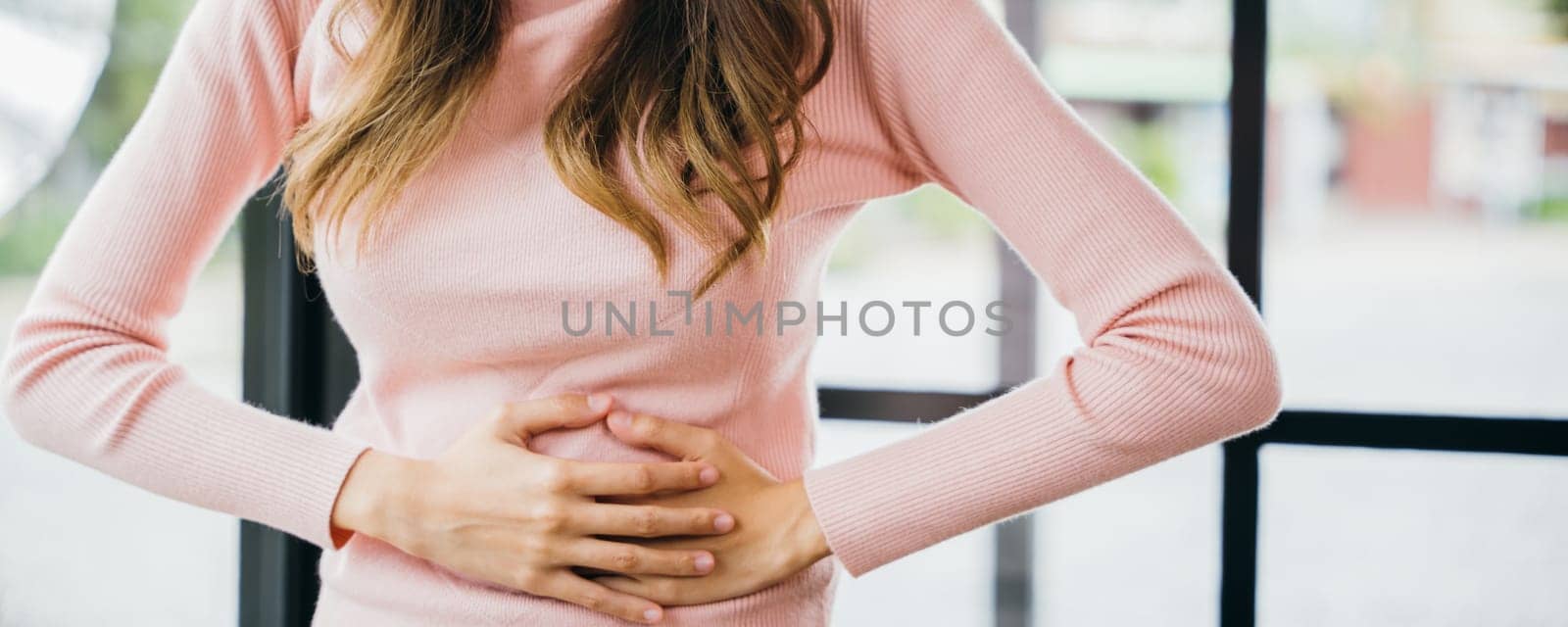 Sick woman unhappy having stomach ache at home, Asian young female suffers from stomachache after eating spoiled food, Abdominal pain from menstrual cramps