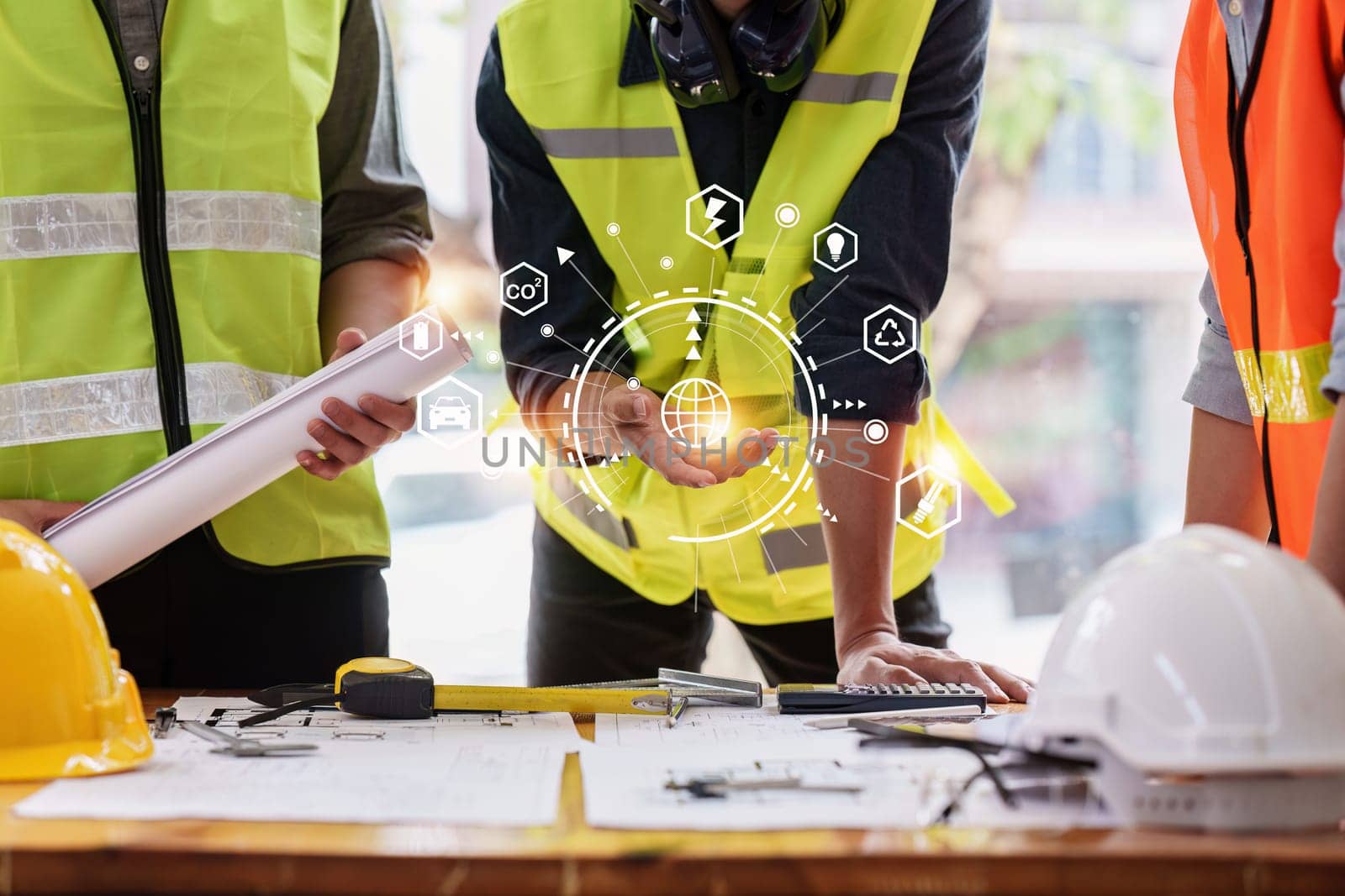 Architect and Engineer working with blueprints for architectural plan, engineer sketching a construction project, green energy concept.