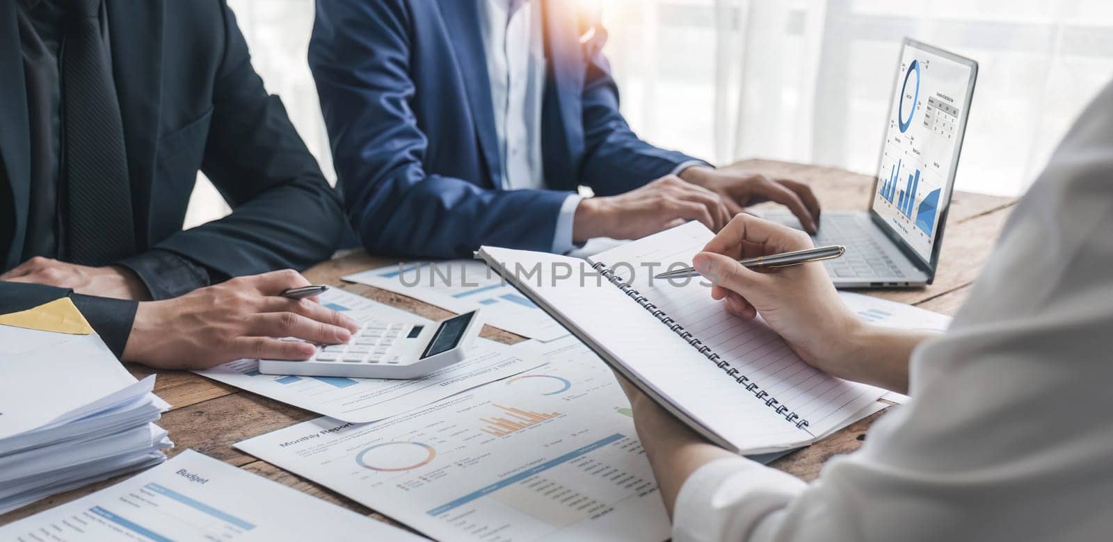 Business People Meeting using laptop computer,calculator,notebook,stock market chart paper for analysis Plans to improve quality next month. Conference Discussion Corporate Concept.. by wichayada