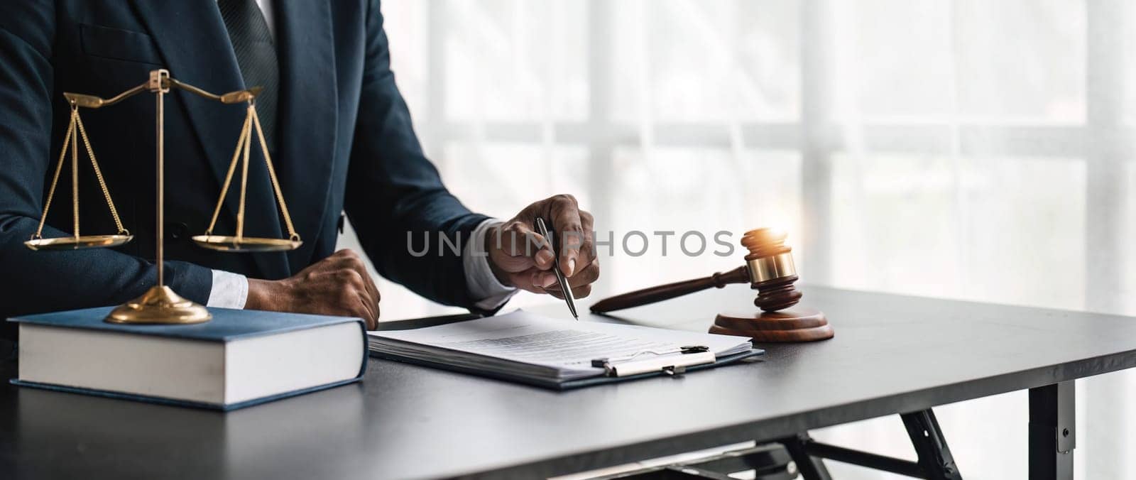 Close up lawyer businessman working or reading lawbook in office workplace for consultant lawyer concept. by wichayada