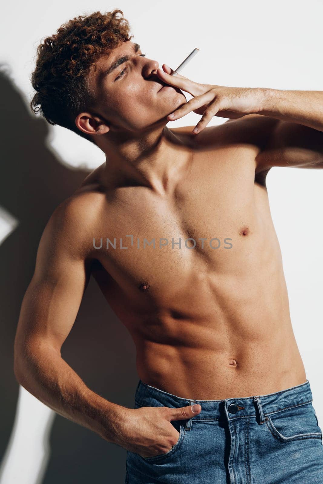 man athletic jeans smoke smokes gray background health guy body cigarette young muscle chest adult gray
