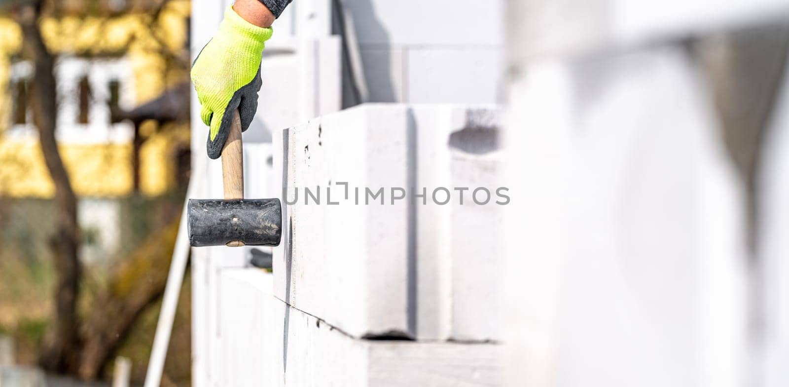 leveling walls with a rubber hammer when building a house. High quality photo