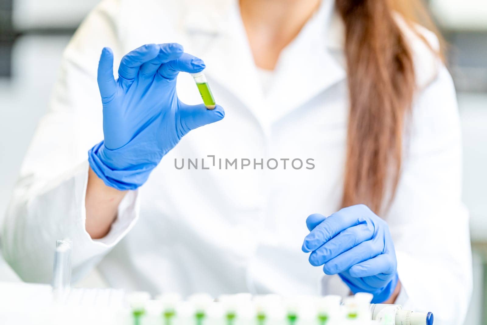 chemical sample in the hand of a scientist in a research laboratory.