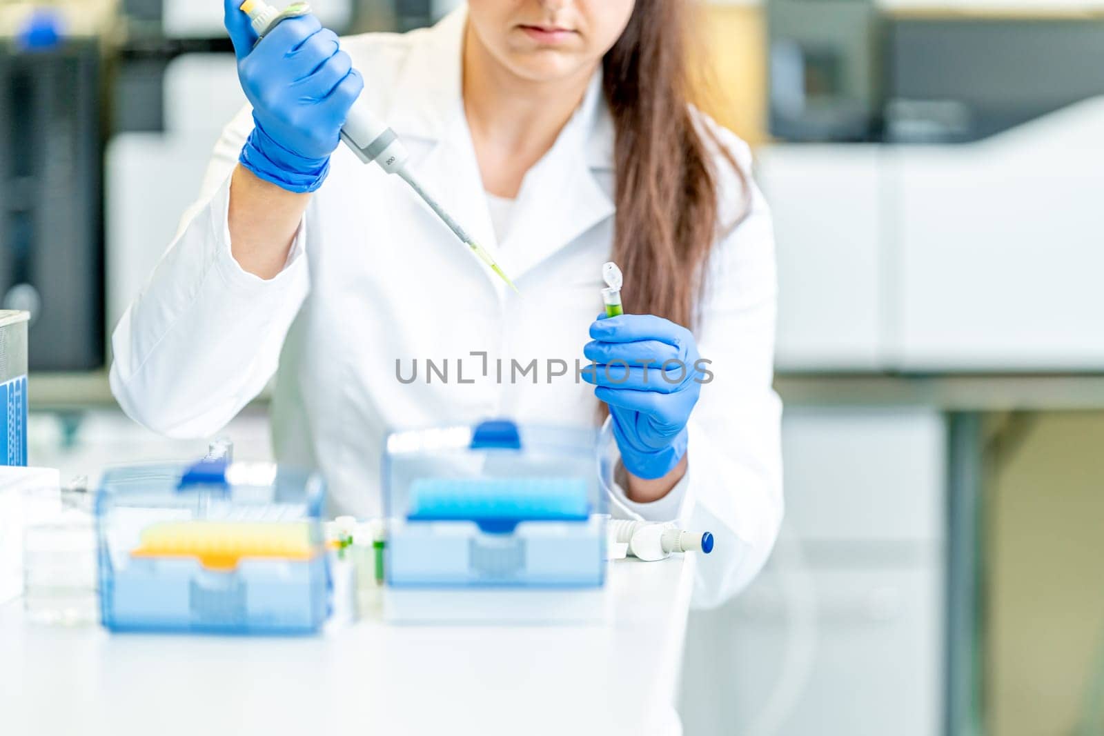 dropper dosing of chemical samples into flasks for research in a scientific laboratory by Edophoto