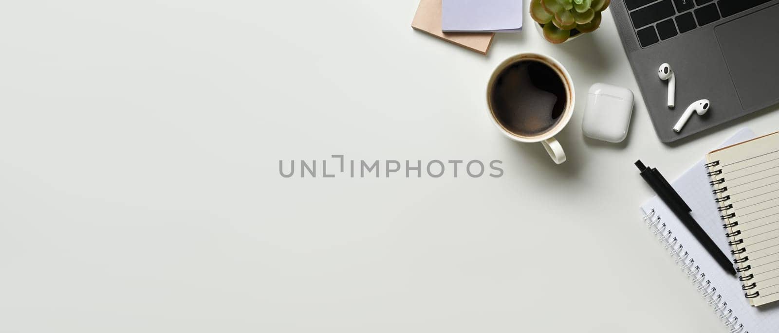 Copy space White office desk table with blank space notebook, laptop and other office supplies. Top view with copy space. by prathanchorruangsak