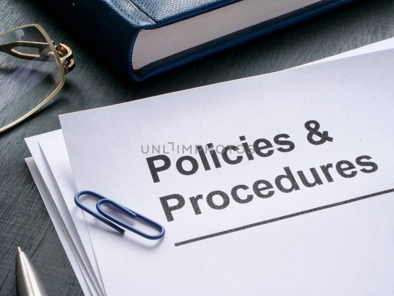 Documents about policies and procedures are on the table. by designer491