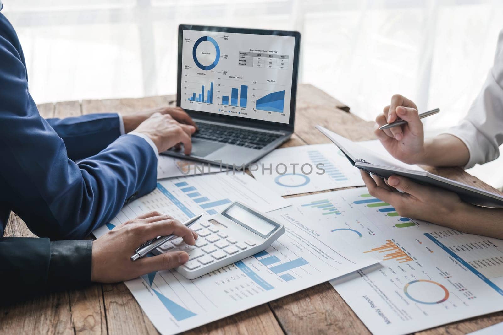 Business People Meeting using laptop computer,calculator,notebook,stock market chart paper for analysis Plans to improve quality next month. Conference Discussion Corporate Concept.. by wichayada