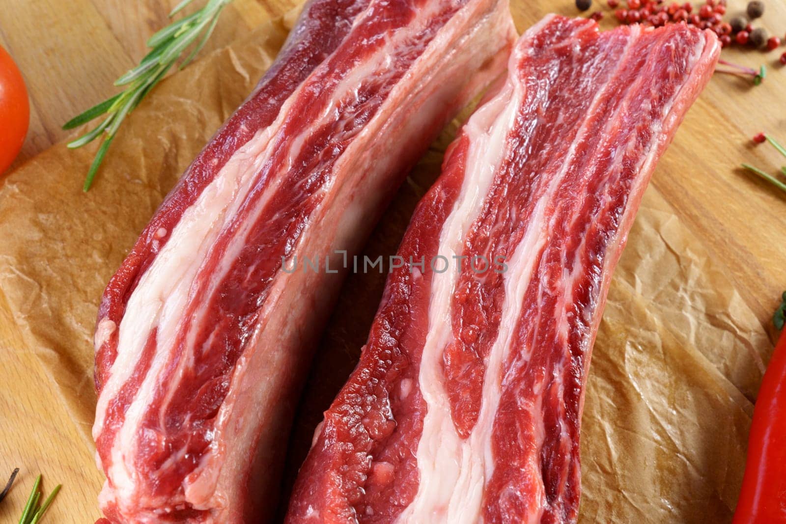 Raw cowboy steak on wooden background, prime rib eye on bone