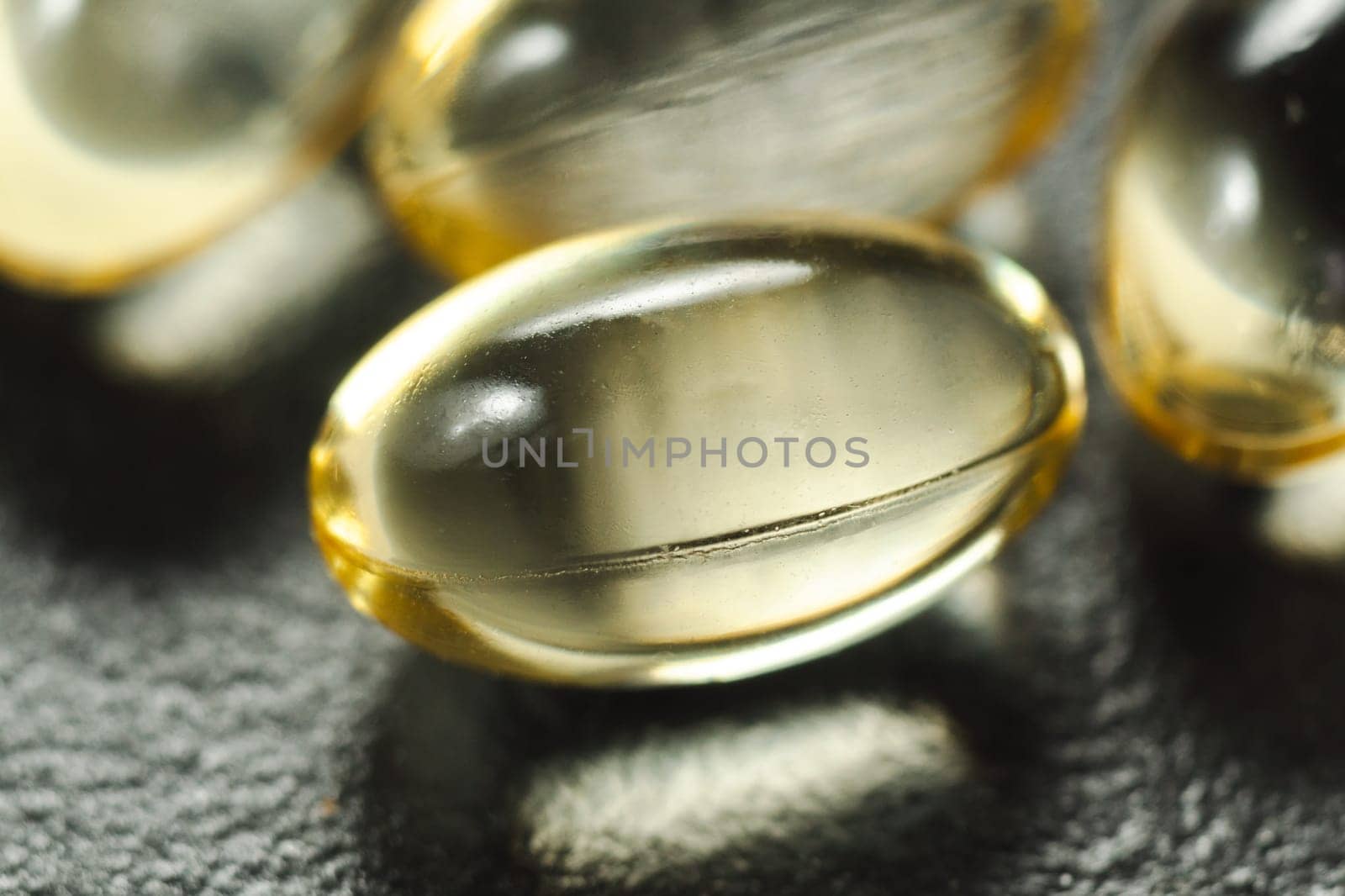 Yellow oil soft gel capsules. Cosmetic pill capsule of vitamin E, A, almond oil, Omega 3, fish. by darksoul72