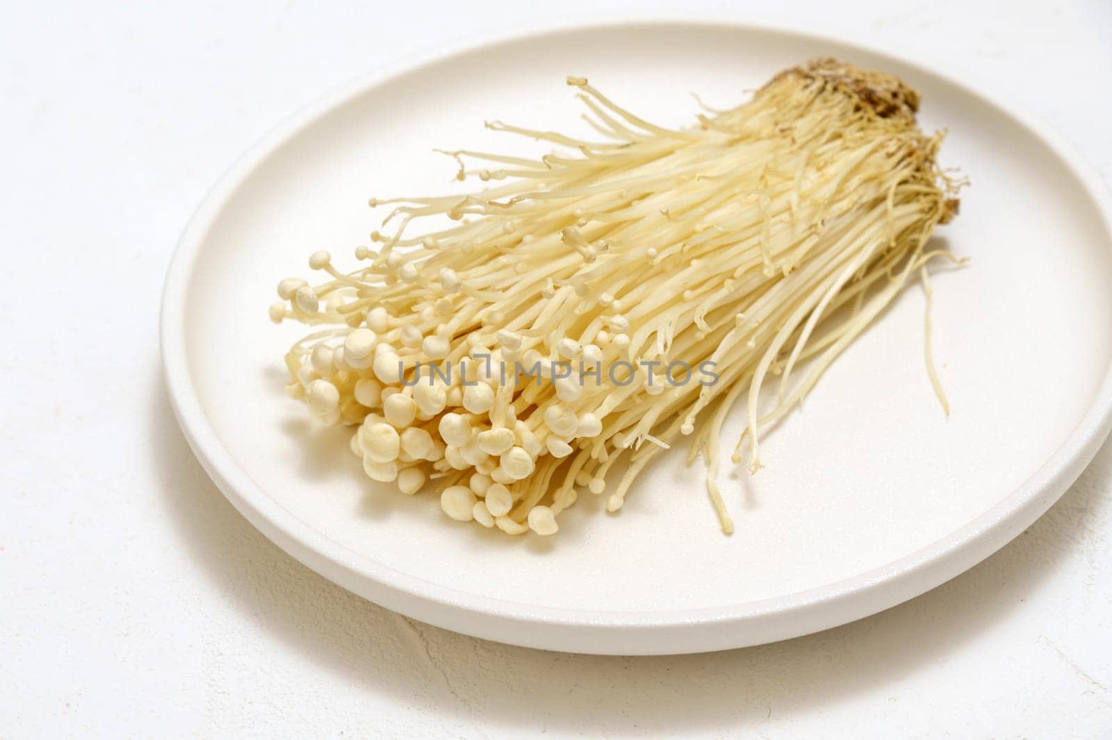 Enoki Flammulina velutipes white mushroom used i food and salads.