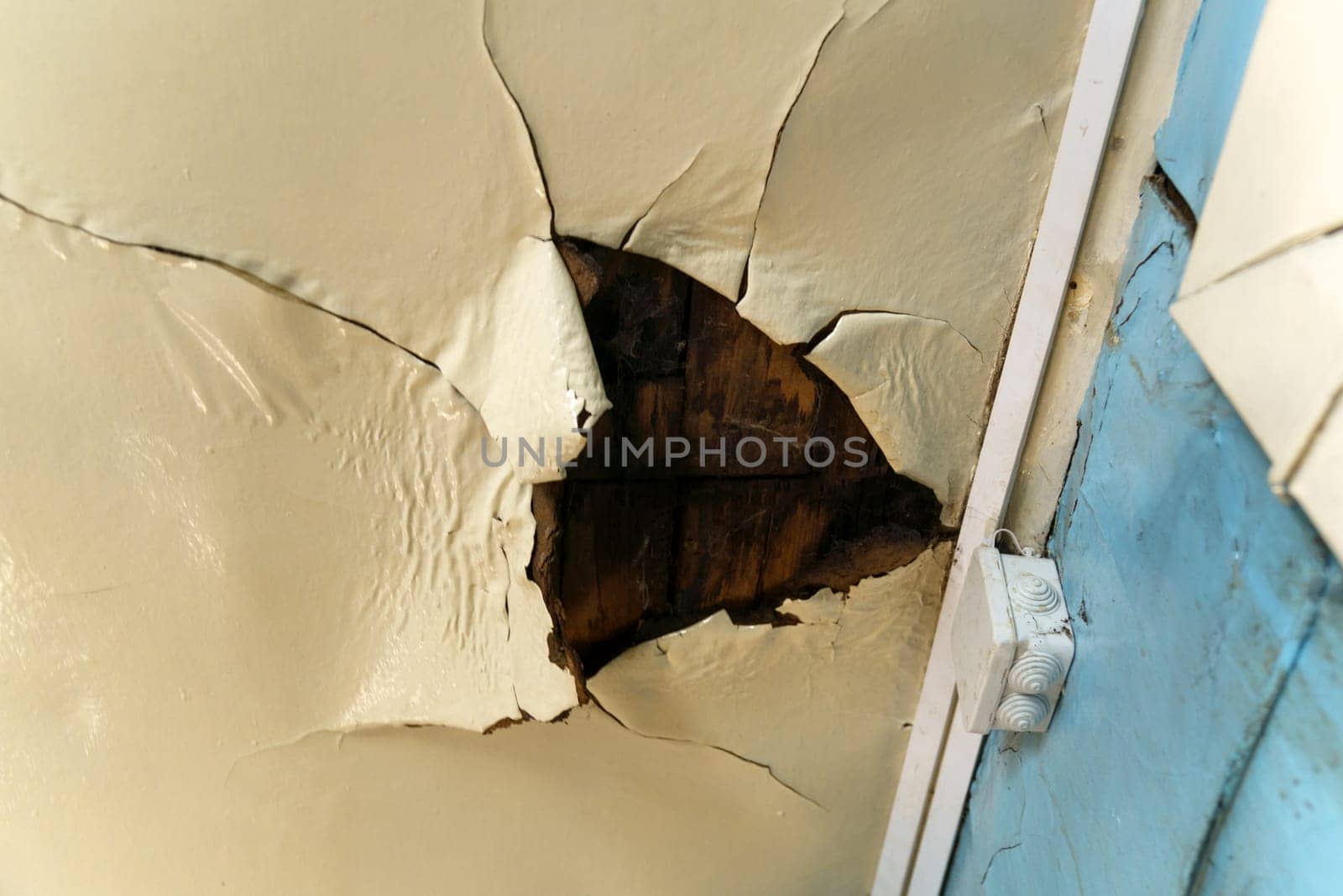 Old ceiling in a wooden house, damaged a huge hole in the roof from rainwater leakage.