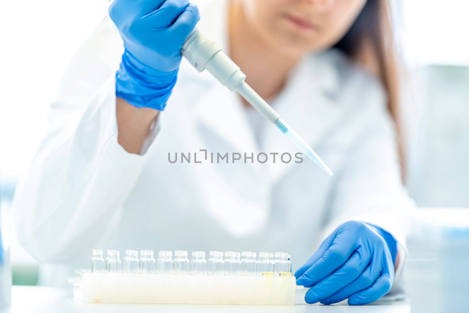 a student of the university science faculty conducts biochemical research in the laboratory by Edophoto