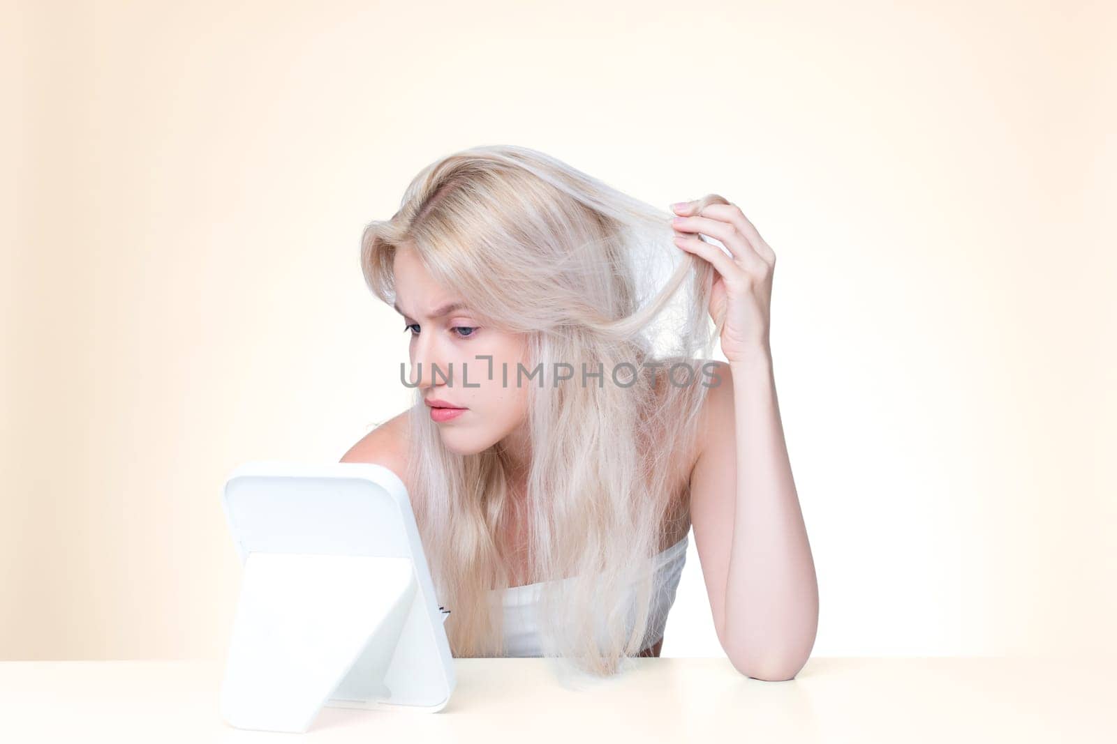 Personable beauty fresh clean skin woman having dry hair problem. Frustrated facial expression concept of damaged hair loss for shampoo ads in copyspace isolated background.