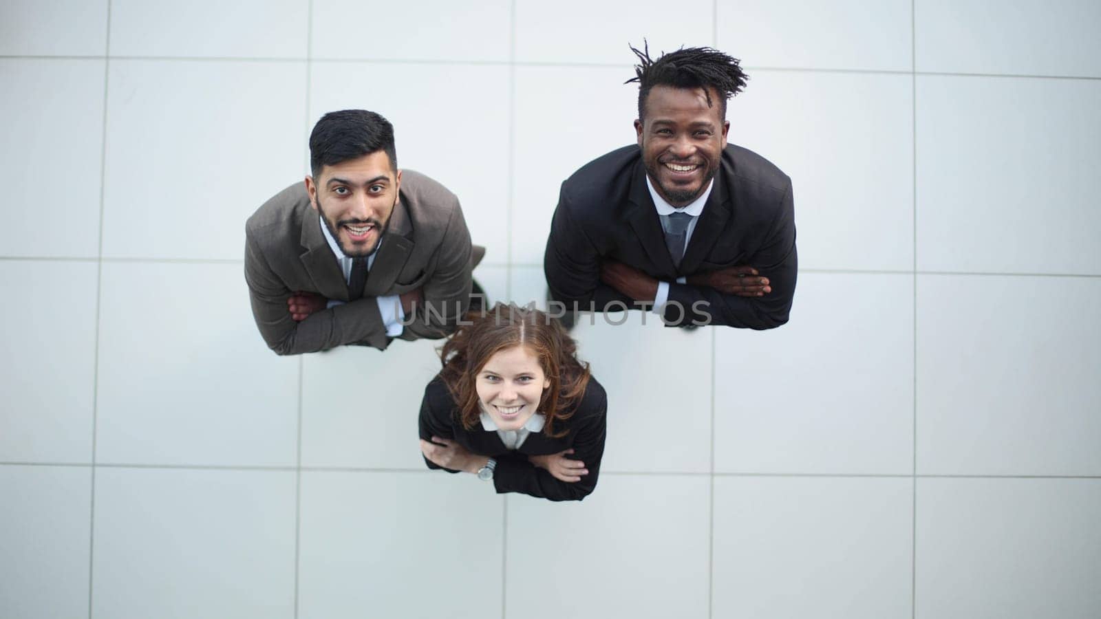 three young people looking at camera up