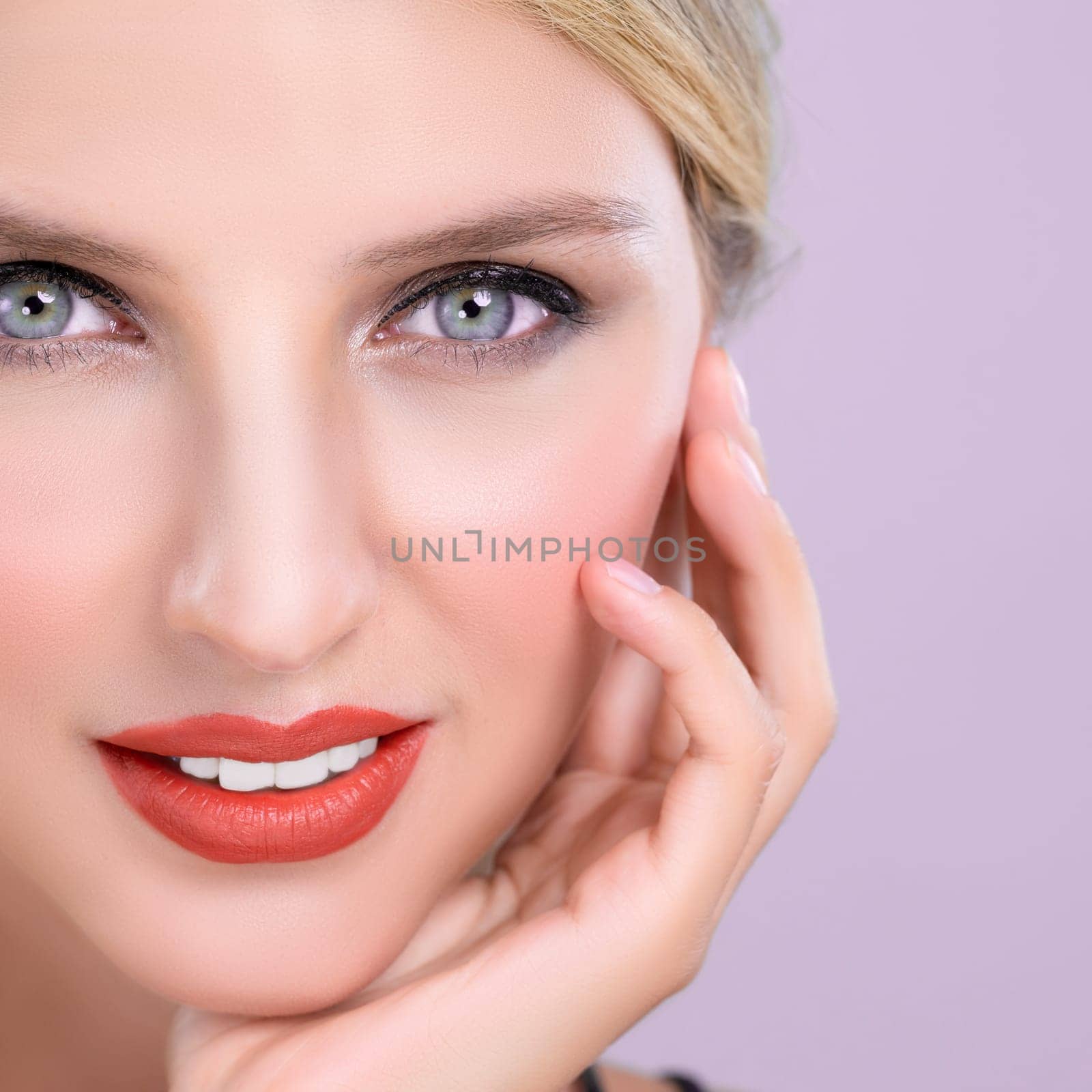 Closeup pretty beautiful woman with alluring perfect smooth and clean skin portrait in pink isolated background. Hand gesture with expressive facial expression for beauty model concept.
