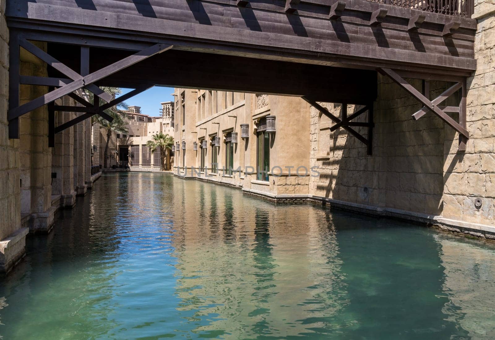 Wooden bridge over waterway in Souk Madinat Junction mall by steheap