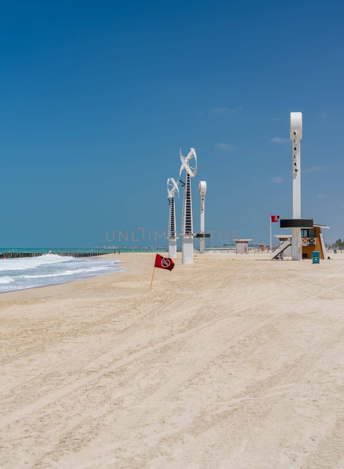 Towers with floodlights and lighting for night swimming at Jumeirah Wild Beach in Dubai