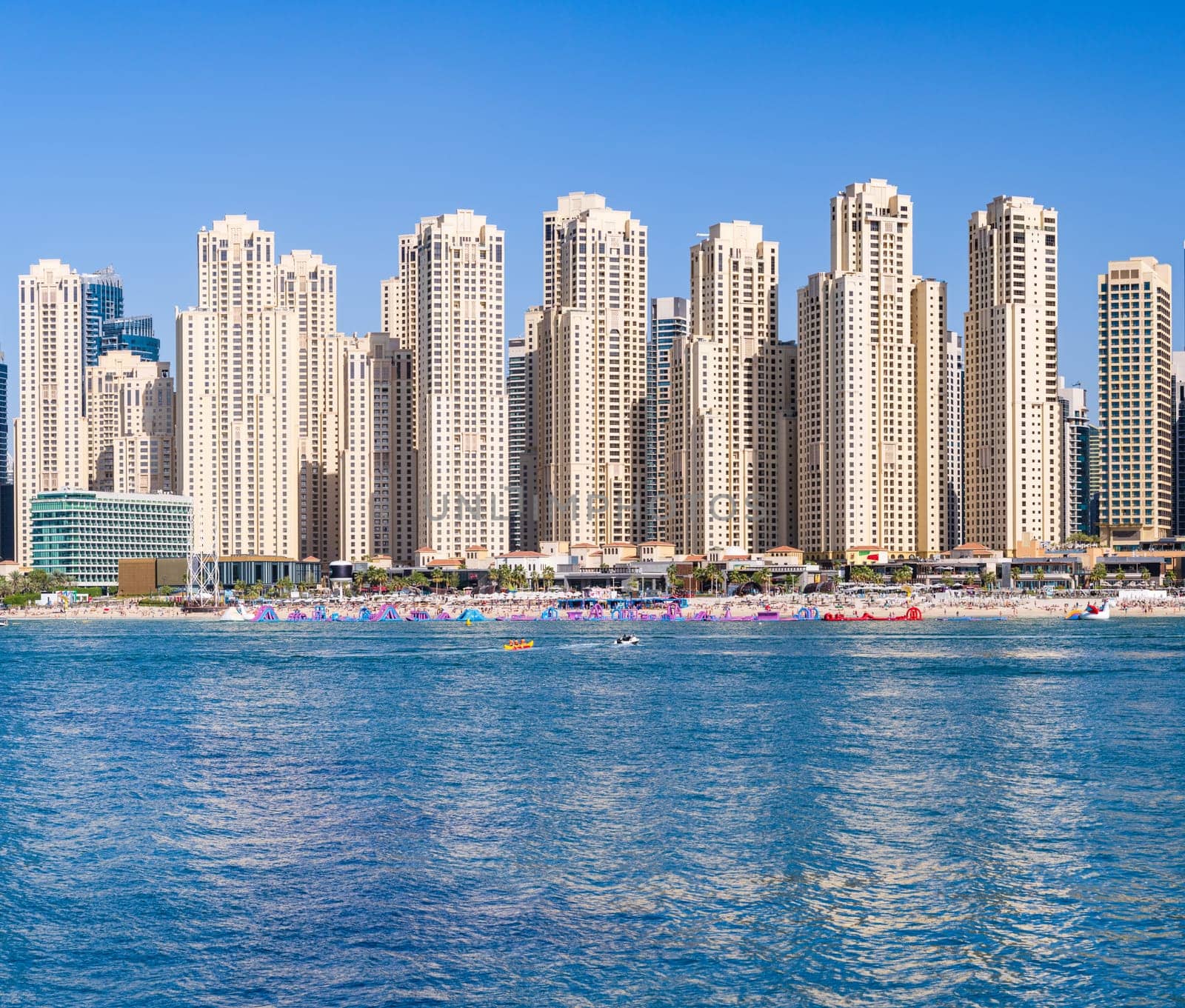 Skyline of hotels and apartments in JBR Beach above the beach by steheap