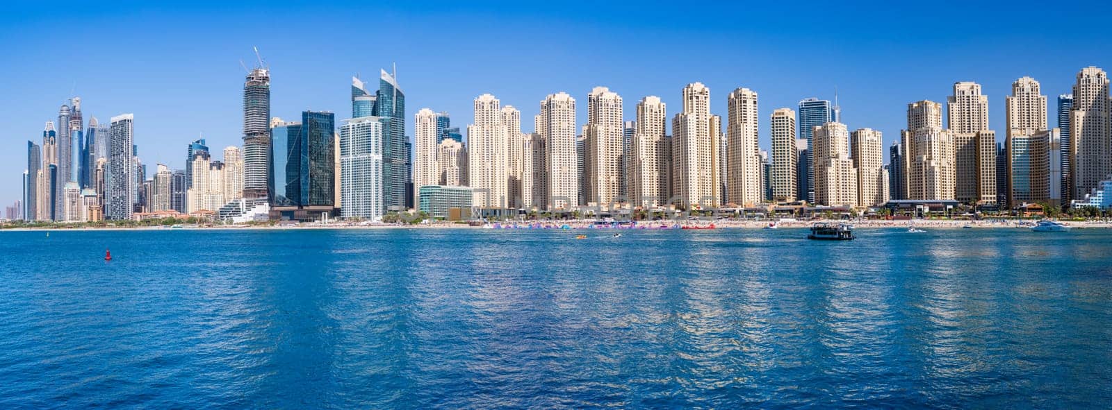 Wide panorama of new apartments among hotels on oceanfront in Jumeirah Beach Residence area of Dubai