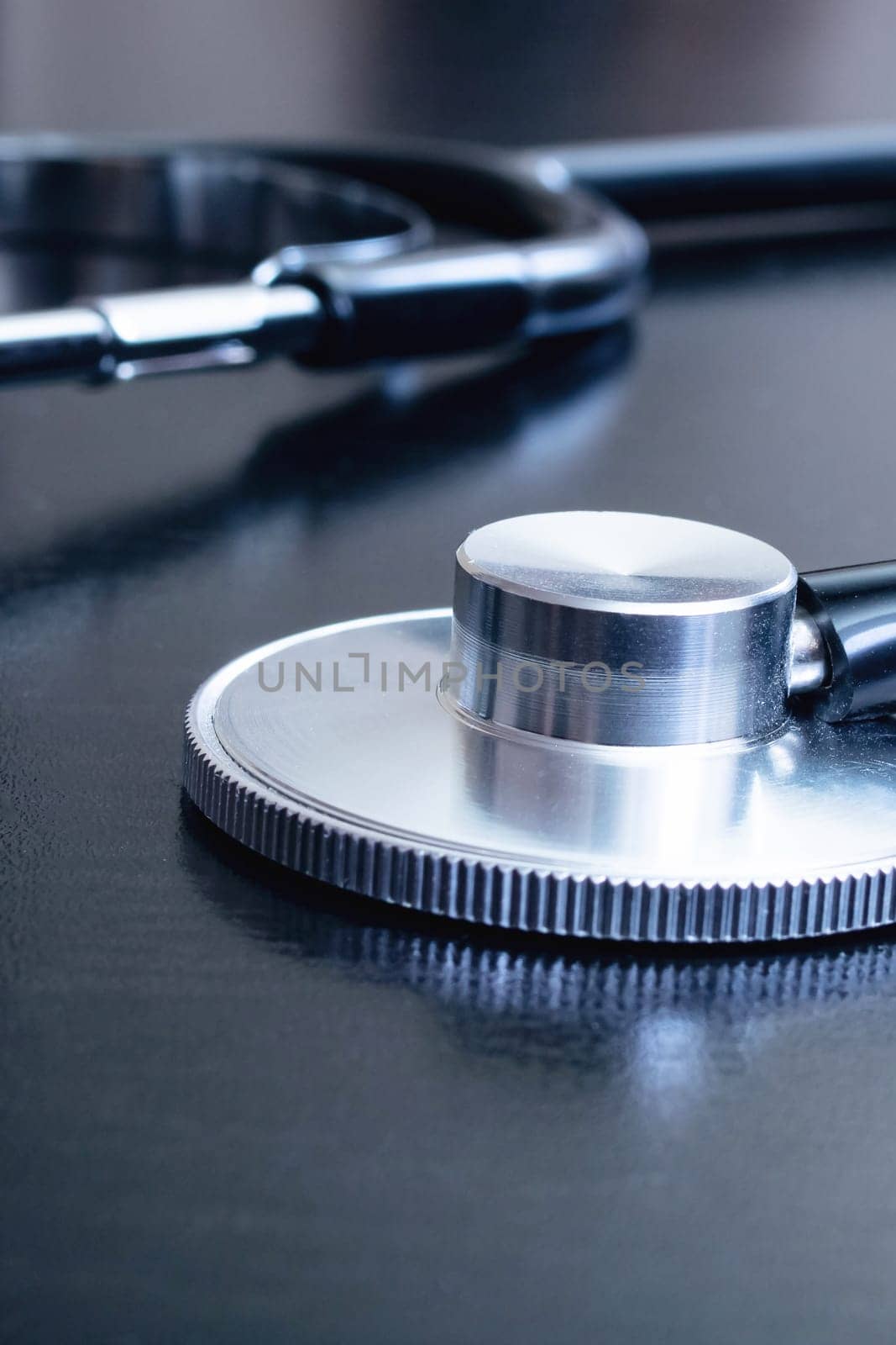 Medical stethoscope on a black table close up