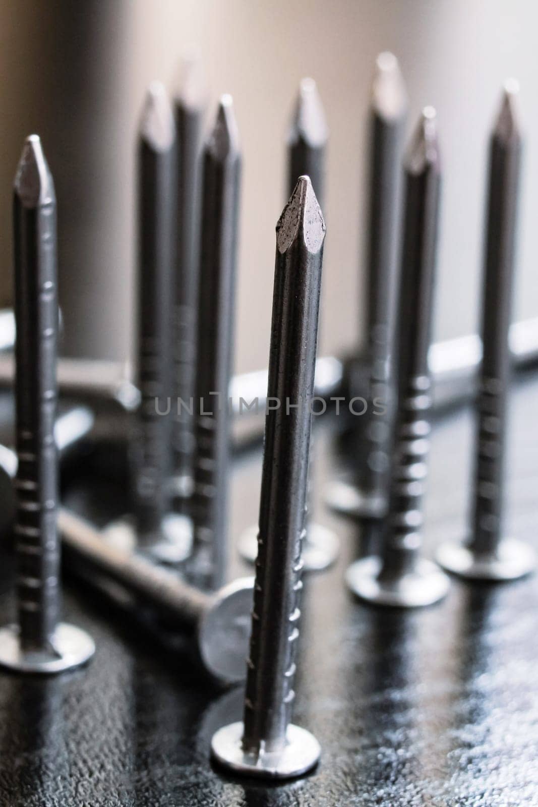 Nails placed in a row on a wooden background