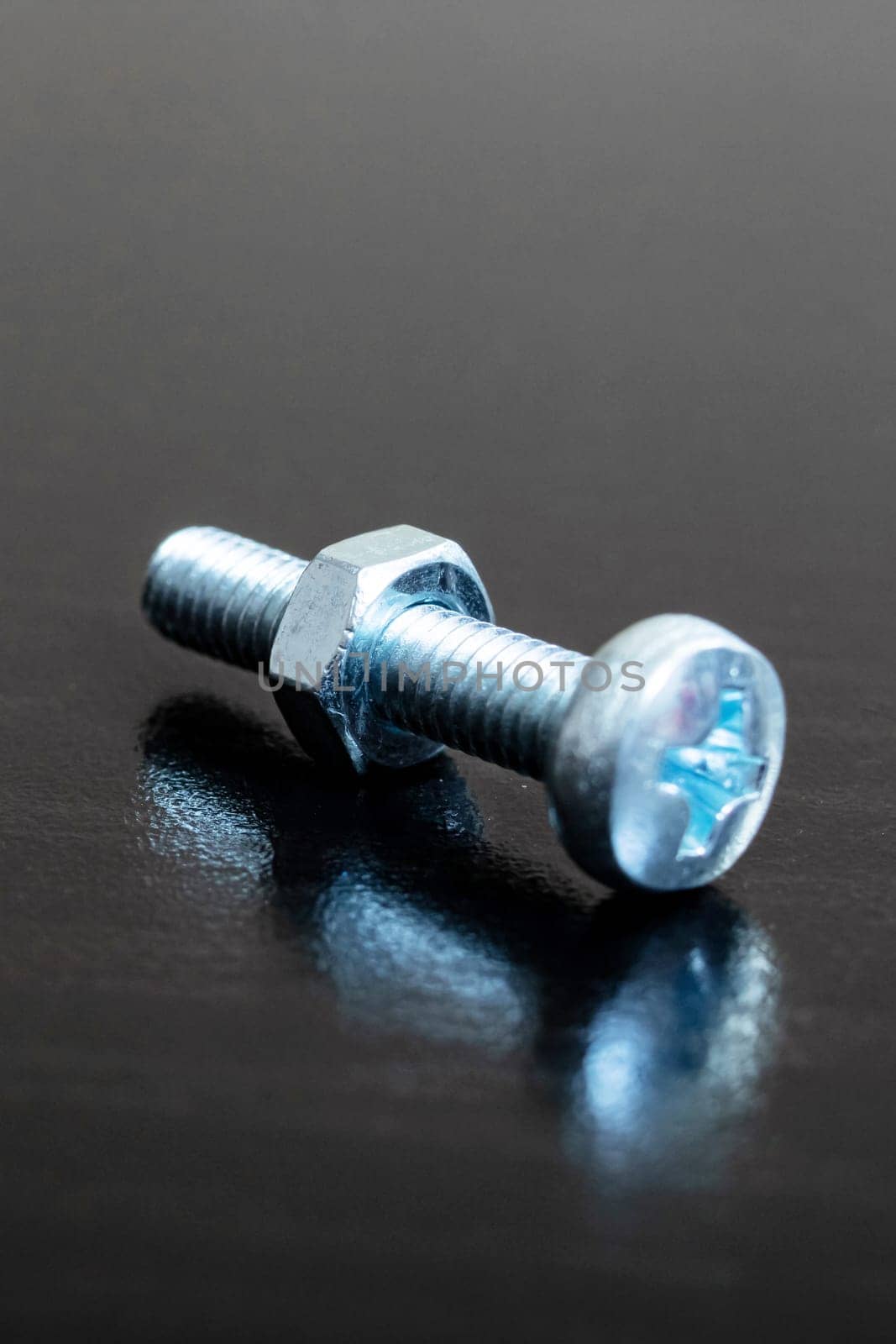 Bolt and nut on a wooden background, copy space