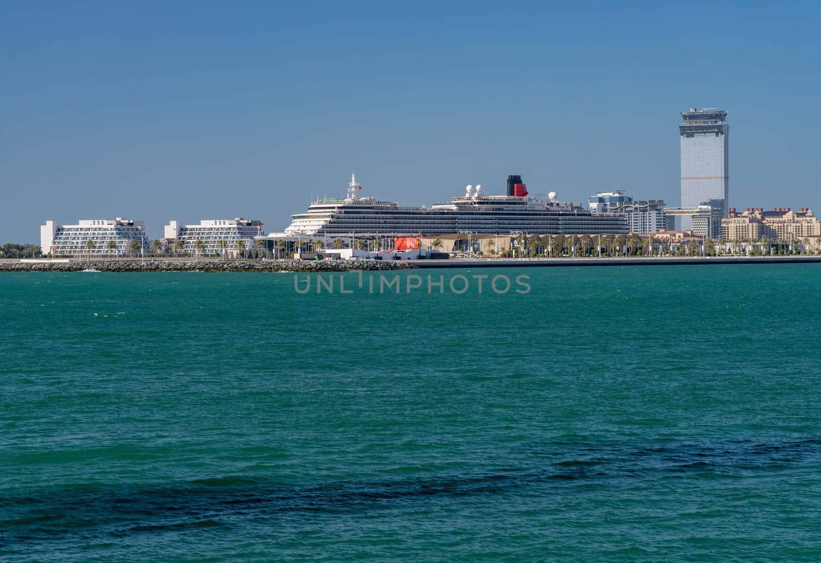 Dubai, UAE - 3 April 2023: Cunard Queen Victoria cruise ship in port by Dubai Marina off JBR Beach