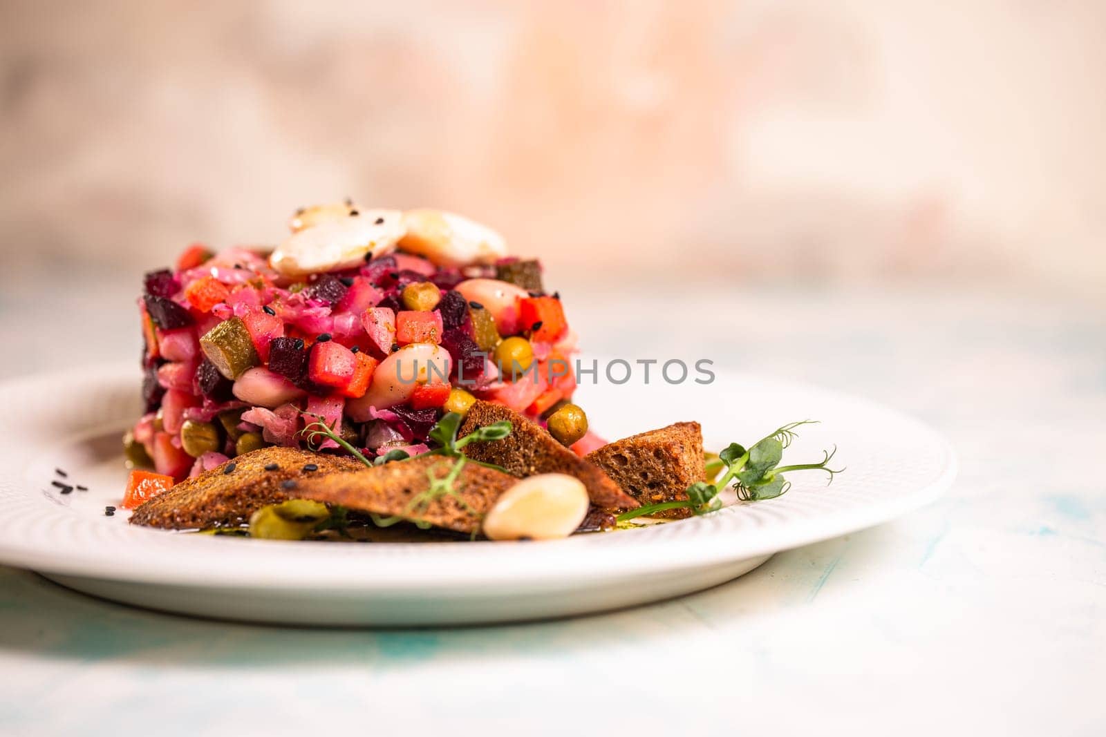 salad vinaigrette with black bread on a plate by Pukhovskiy