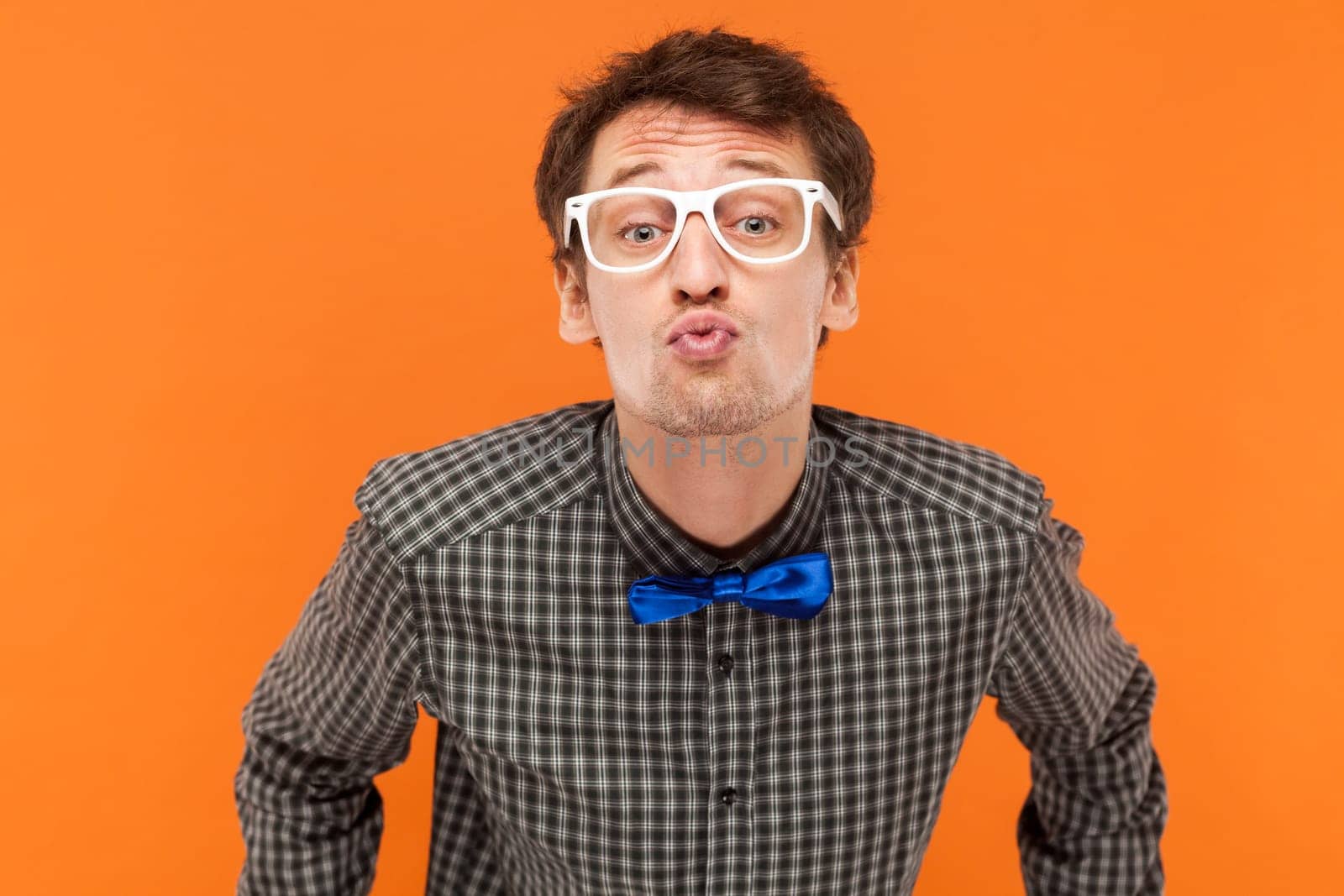 Man nerd keeps lips folded, expressing love, blows mwah, has romantic expression, by Khosro1