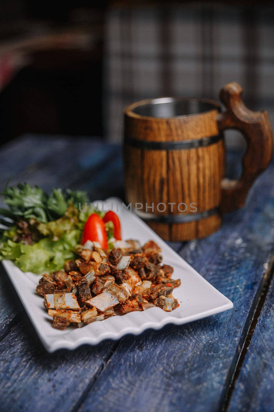 appetizer of small fried ribs on a white plate by Pukhovskiy