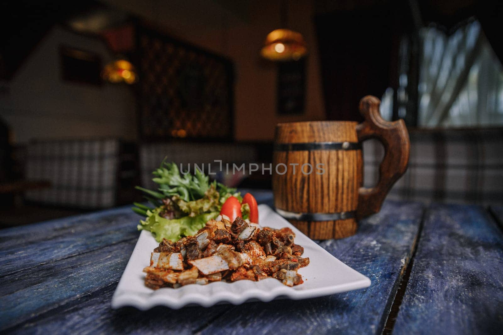 appetizer of small fried ribs on a white plate.