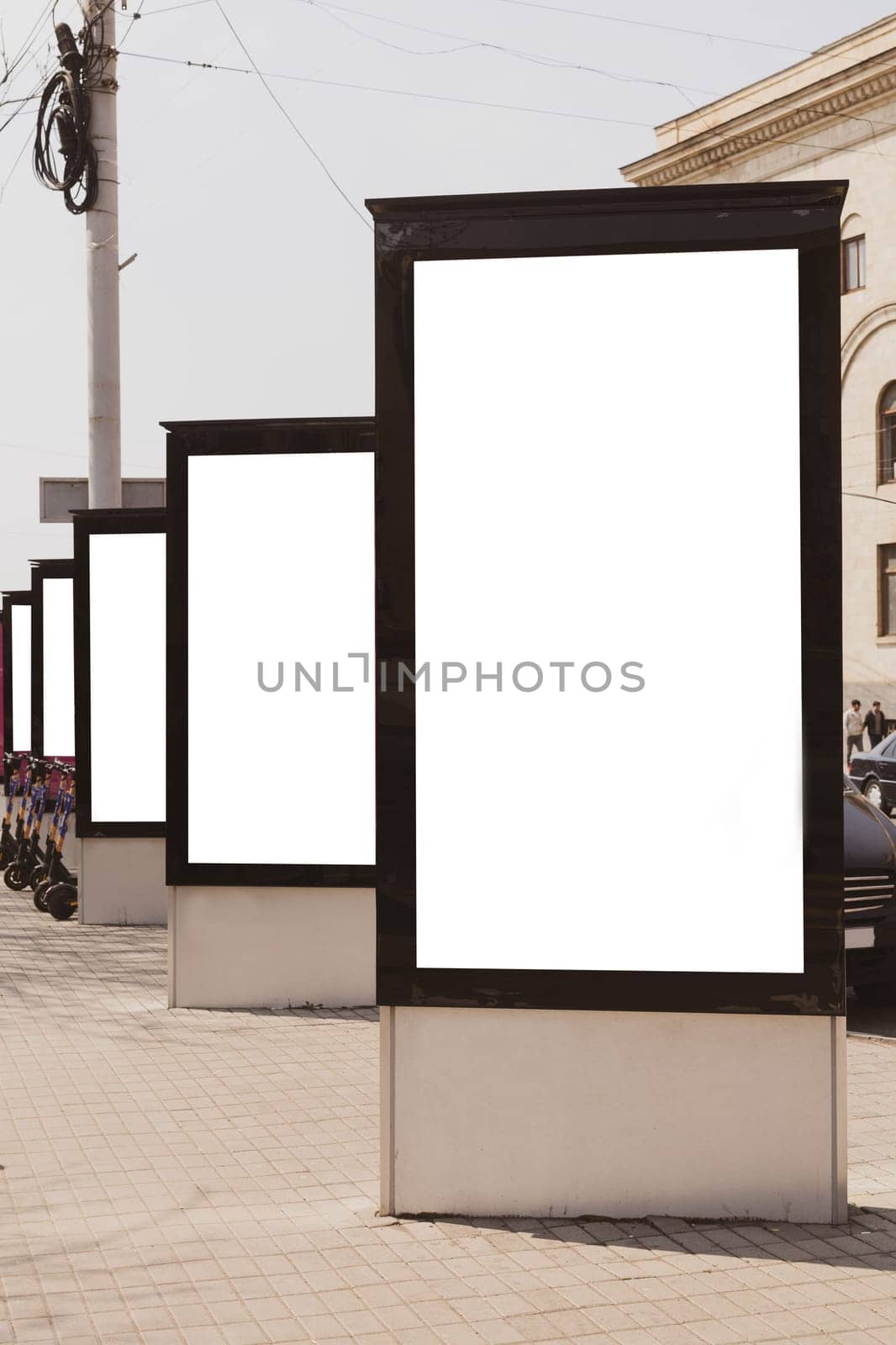 Blank mock up of vertical street poster billboards on city background