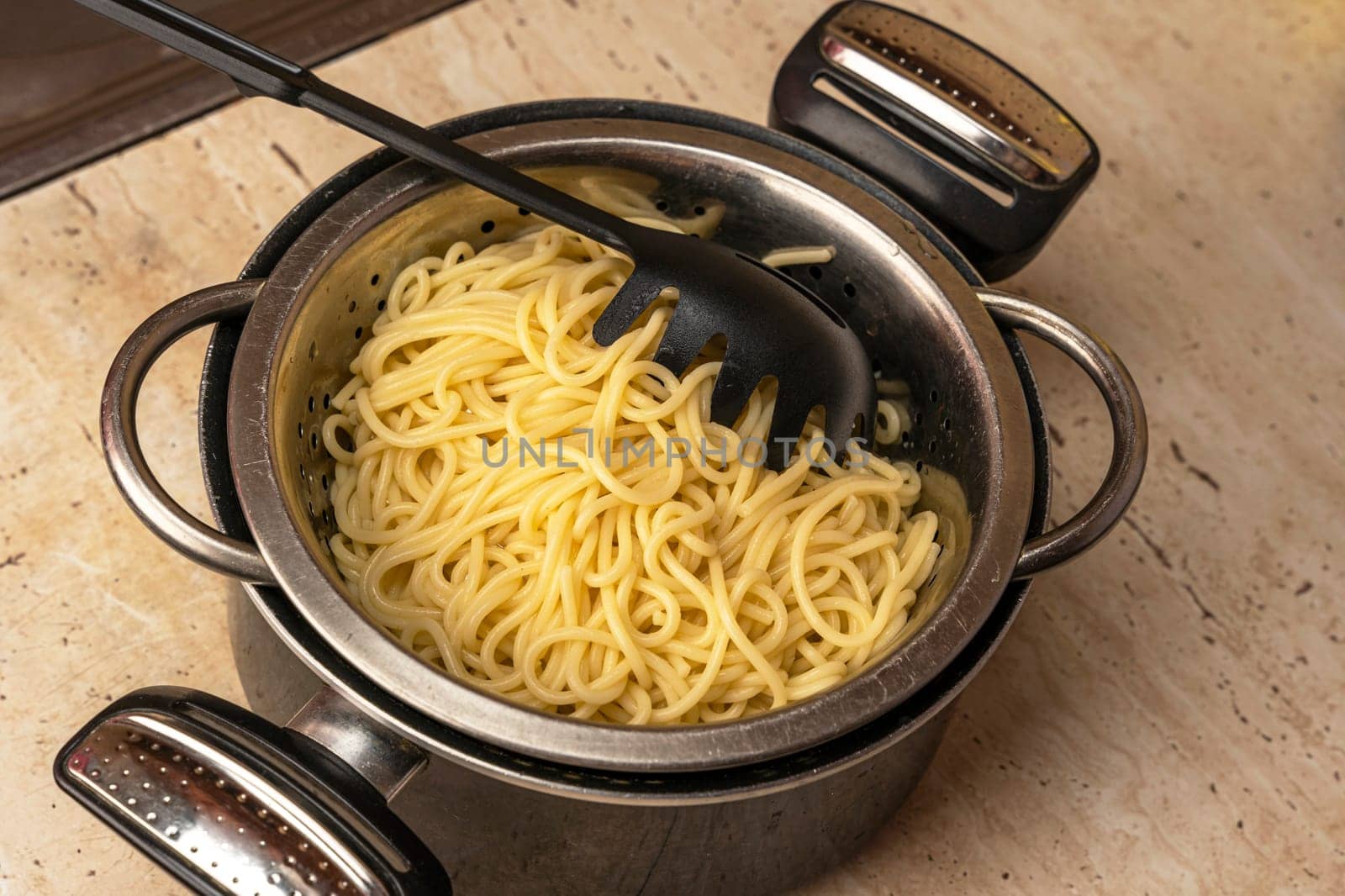 boiled ready-made spaghetti in a colander and a kitchen saucepan by audiznam2609