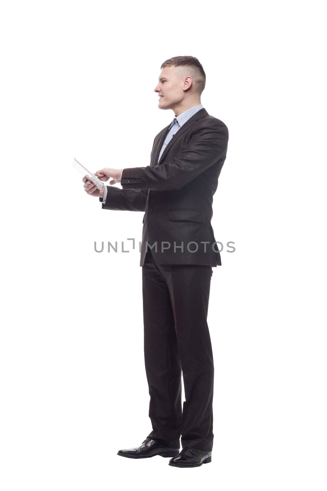 in full growth. happy young businessman with a digital tablet . isolated on a white background.