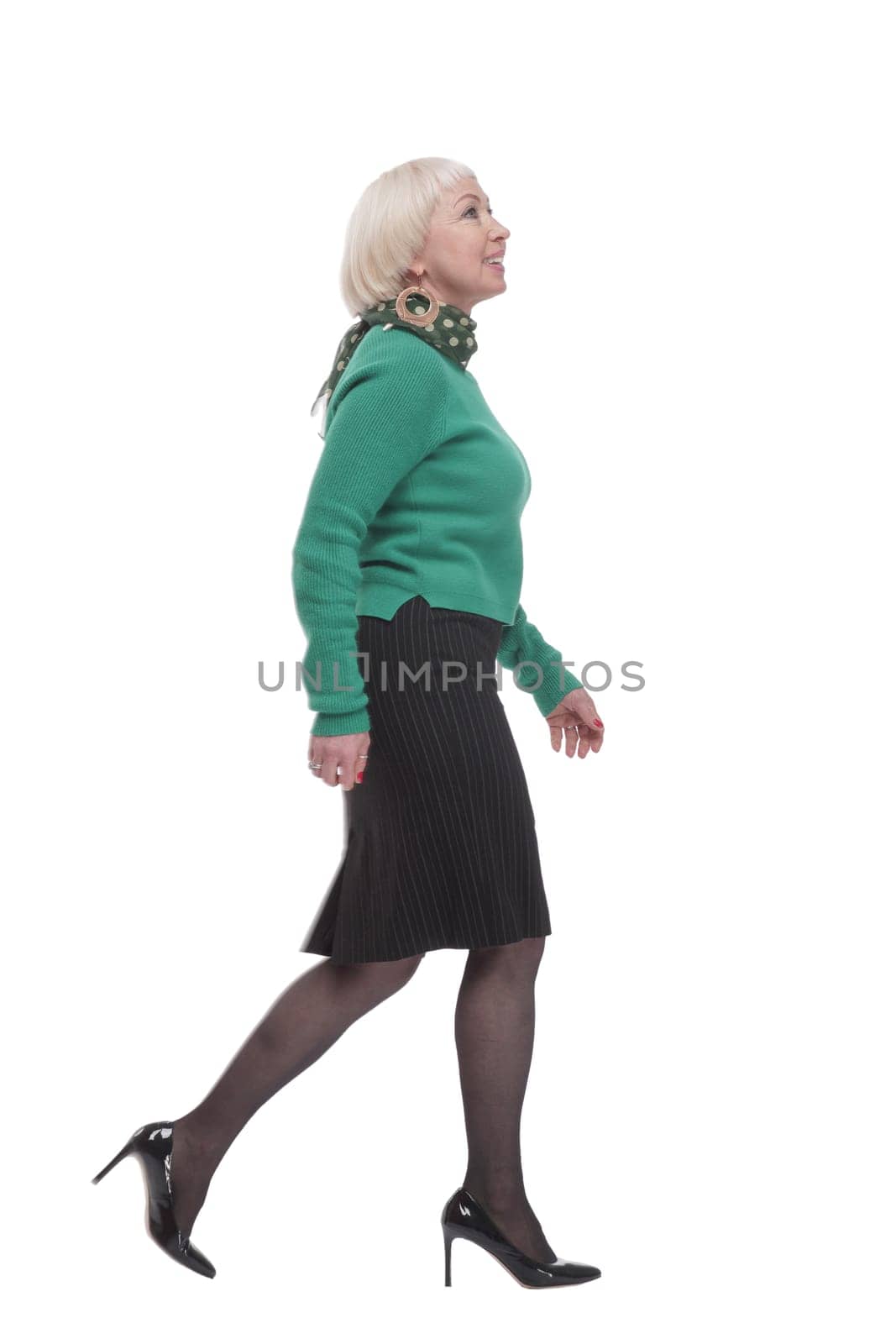 in full growth. woman in a green jumper striding forward. isolated on a white background