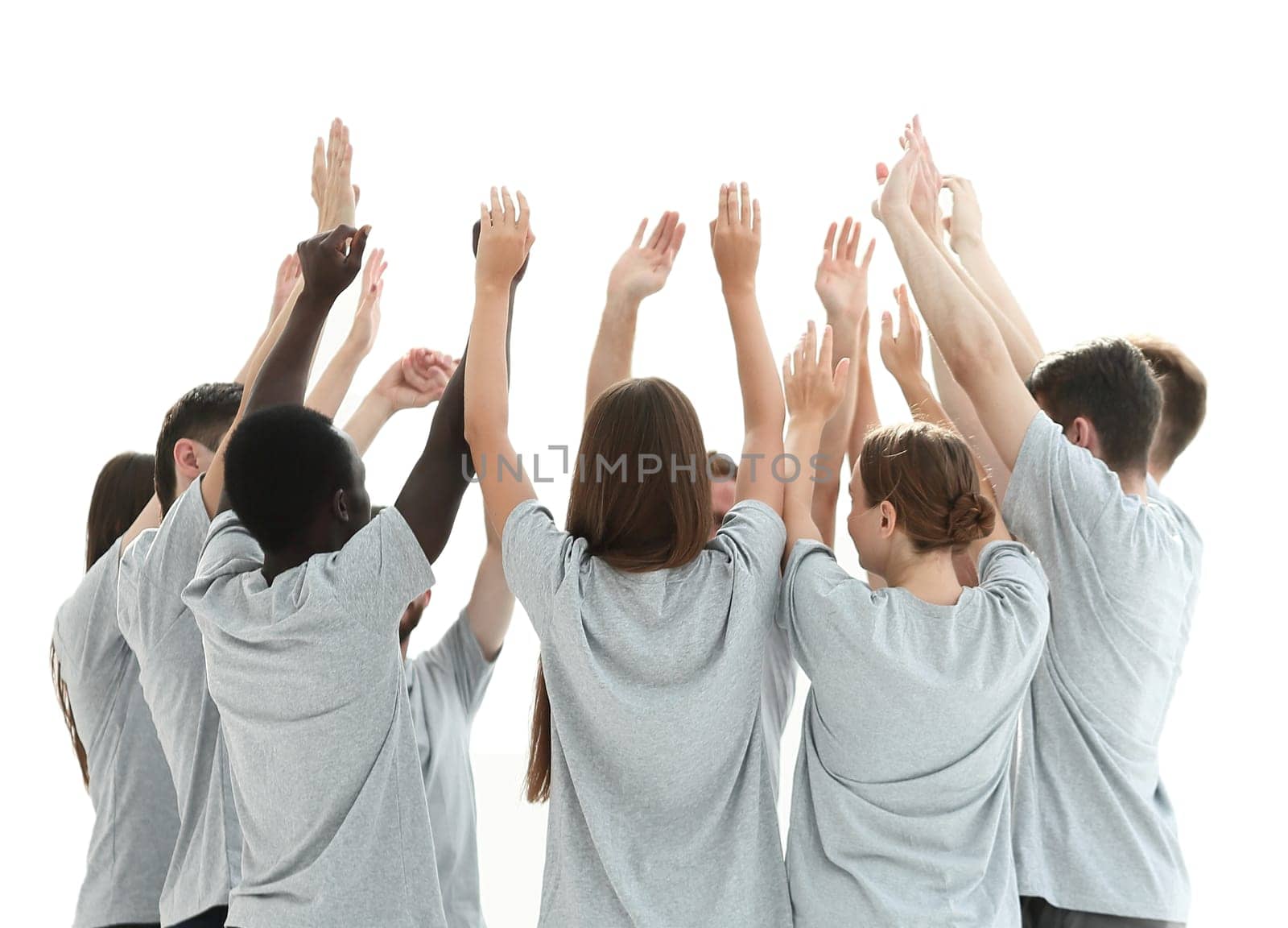 in full growth. group of young people standing in a circle with hands up. photo with copy space