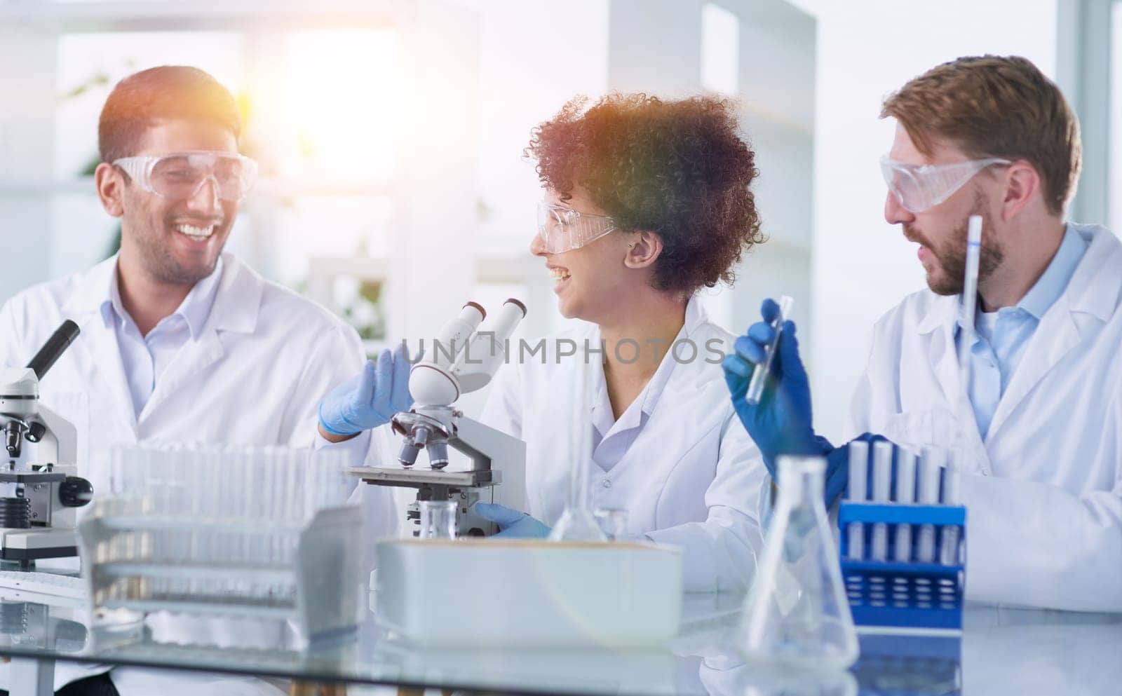 Team of Scientists Working Using Microscope, Analysing Microbiology Samples